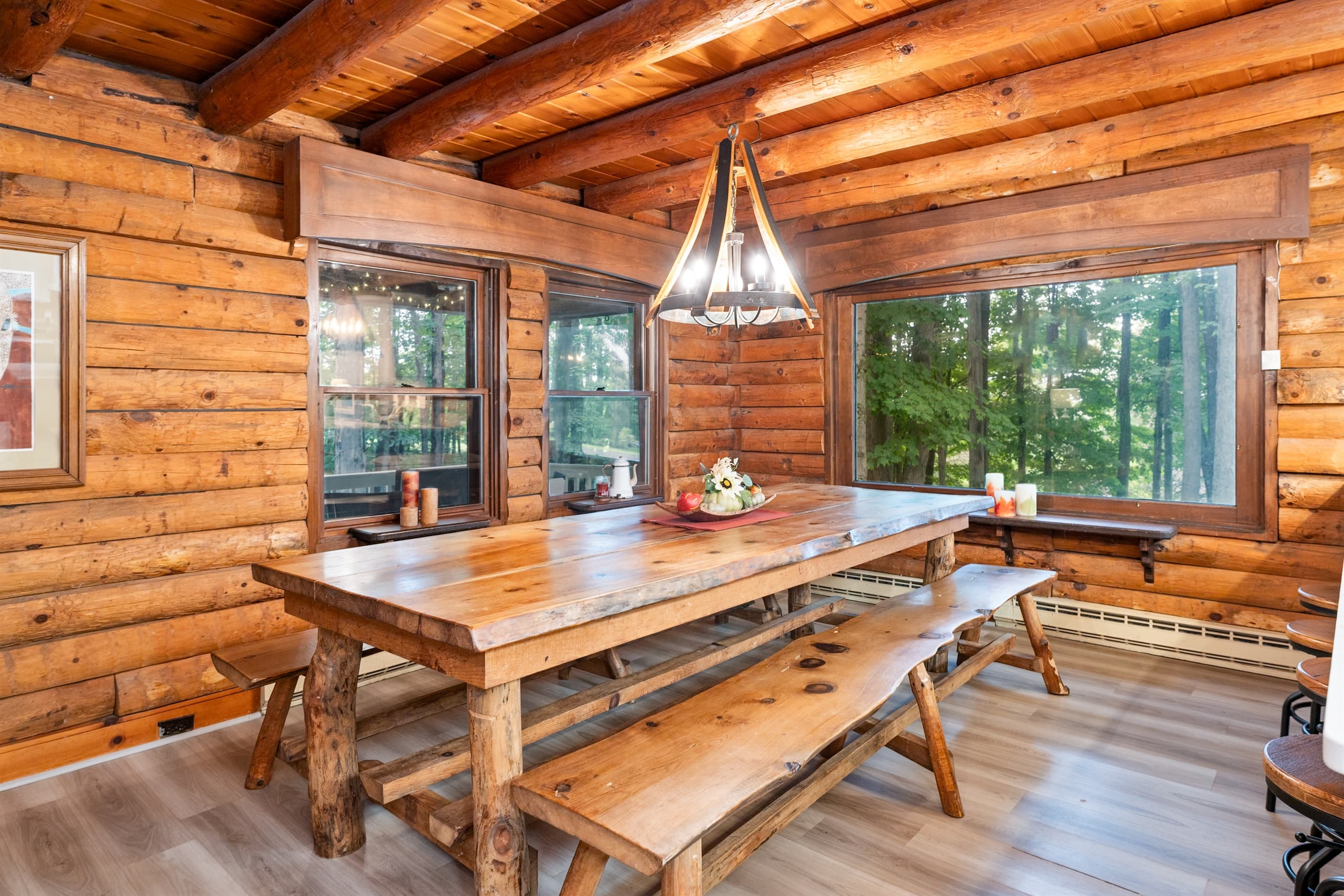 Dining area with long table and forest views