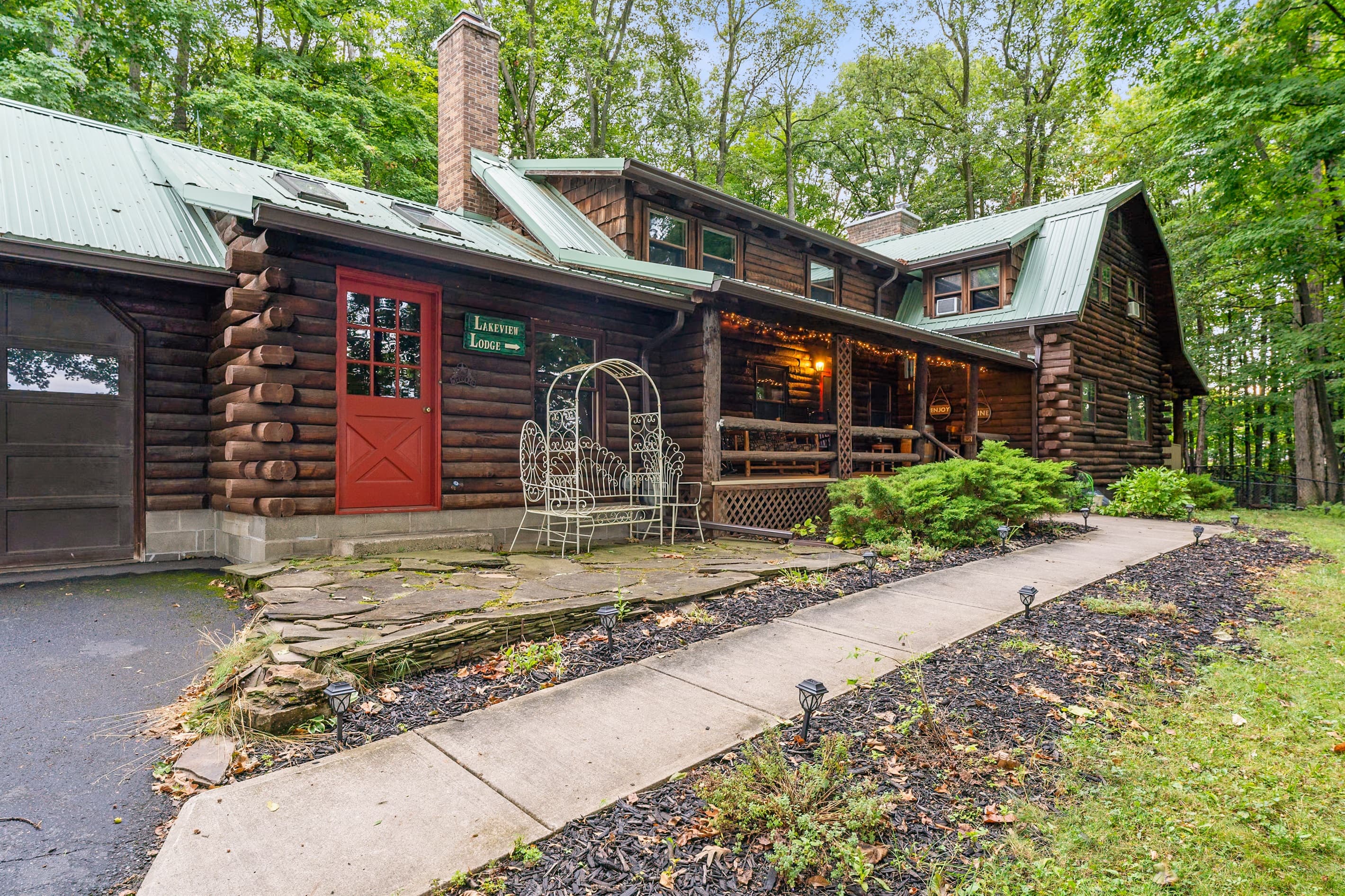 Log cabin exterior with stone walkway and porch