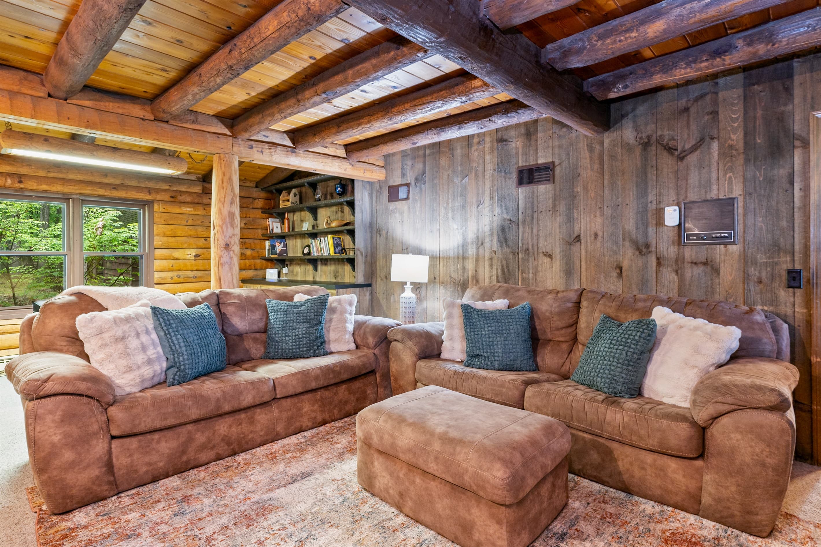 Wood-paneled living room with exposed ceiling beams