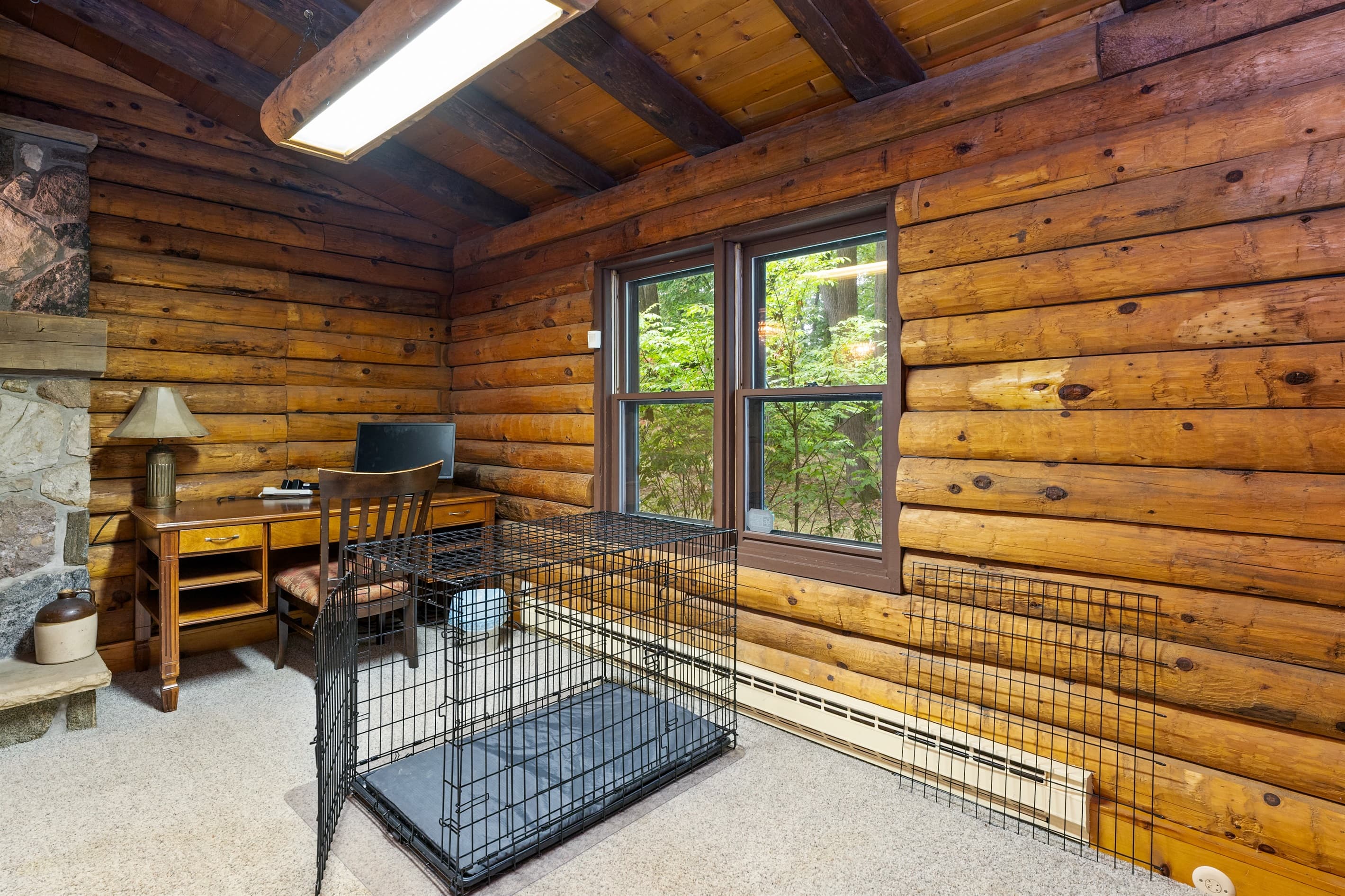 Wood-paneled log cabin with a dedicated workspace