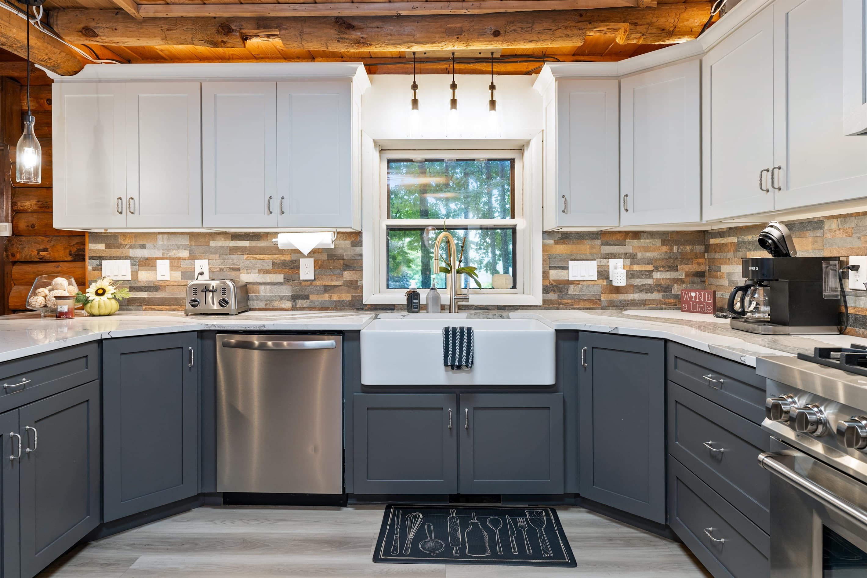 Kitchen with white cabinetry and stone backsplash