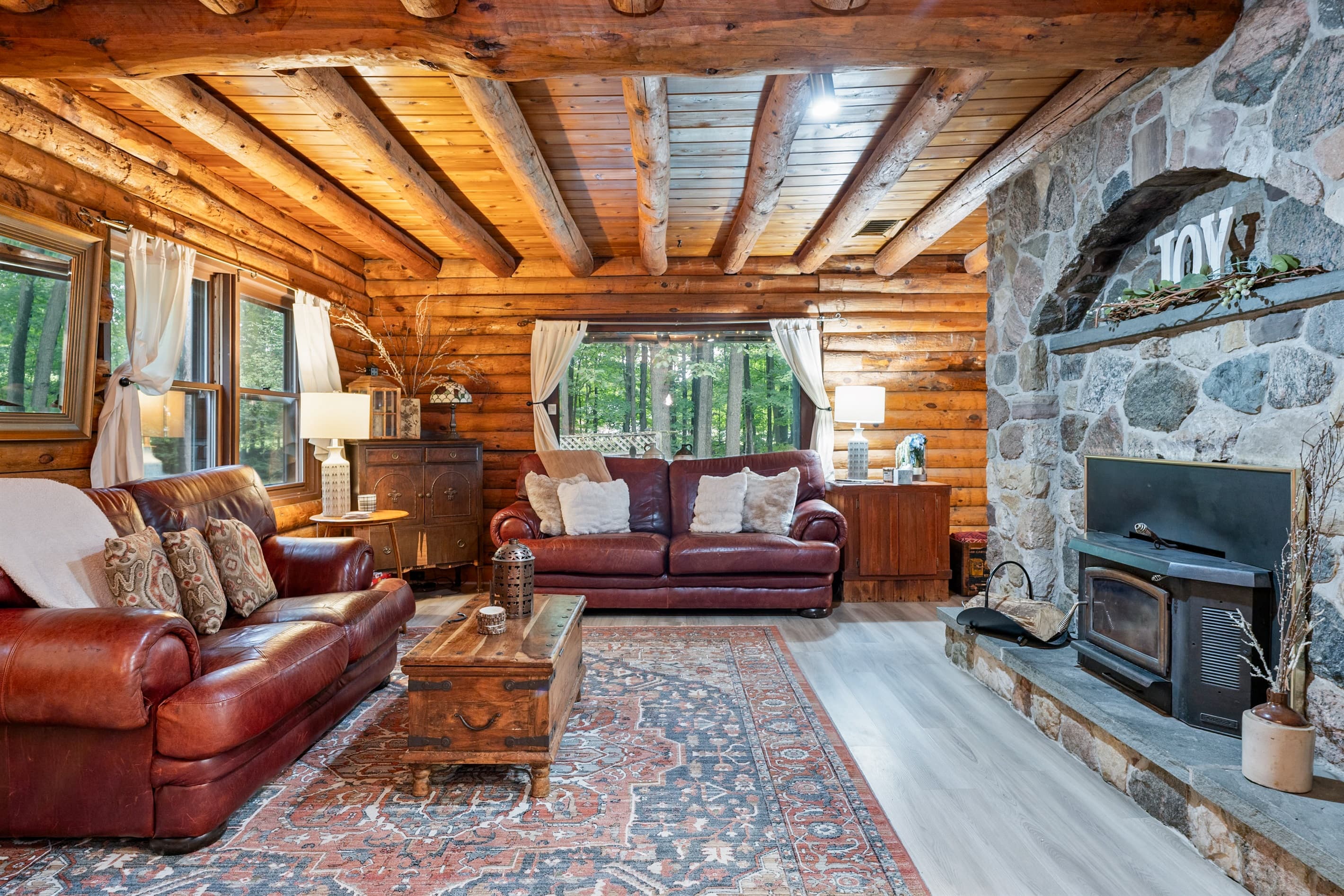 Living room with stone fireplace and leather seating