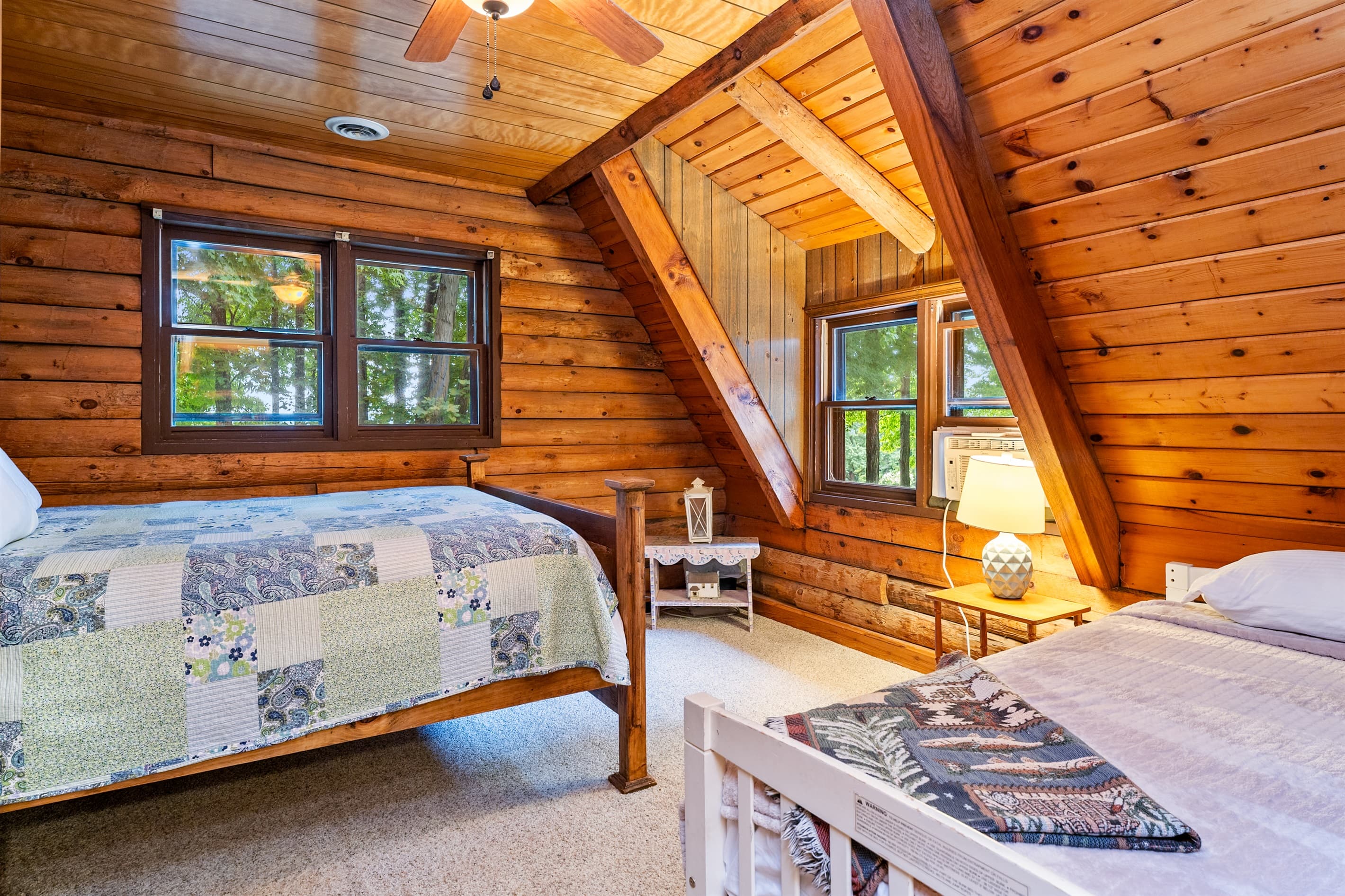 Wood-paneled bedroom with two beds