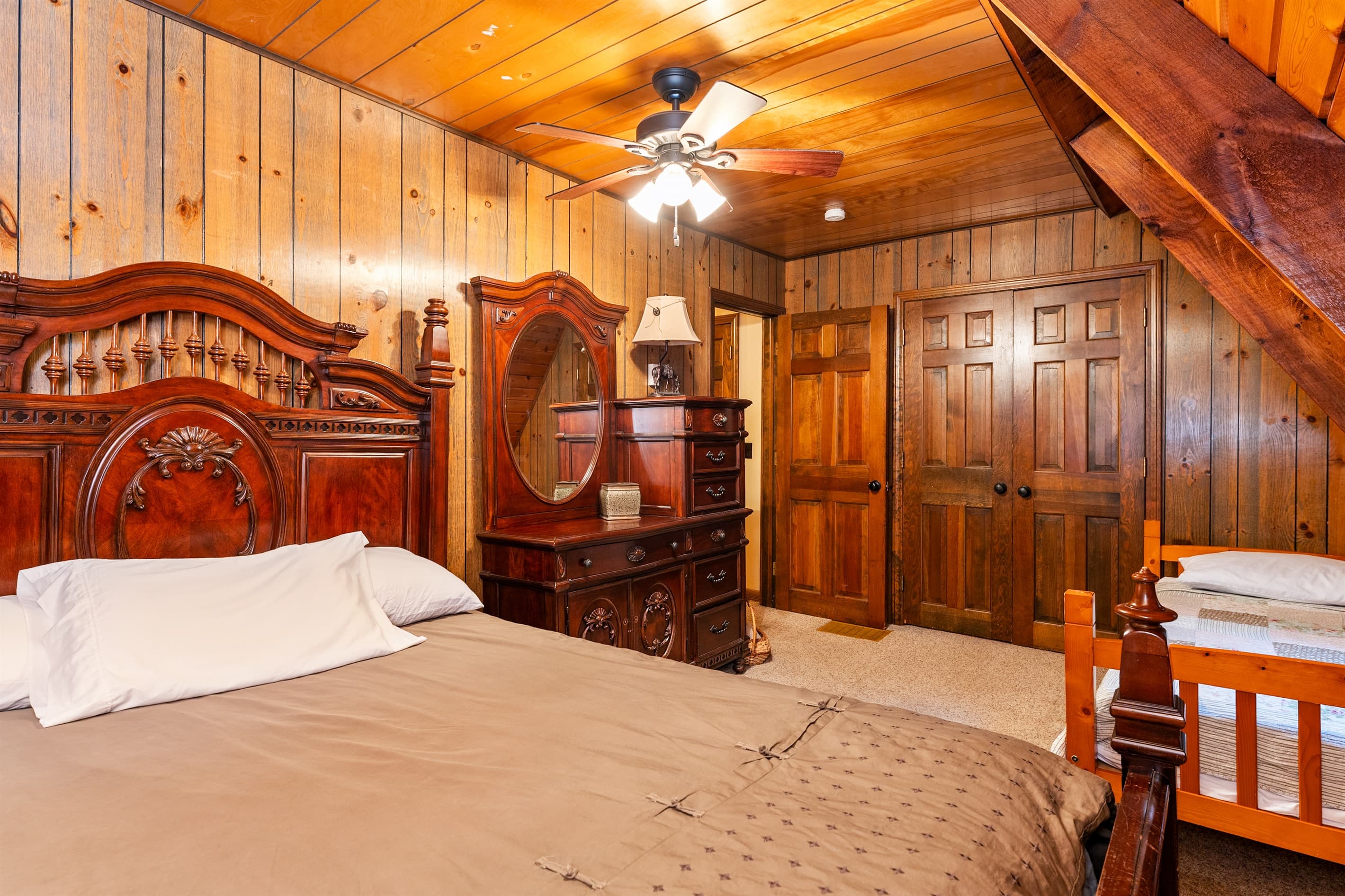 Bedroom with ornate wooden headboard