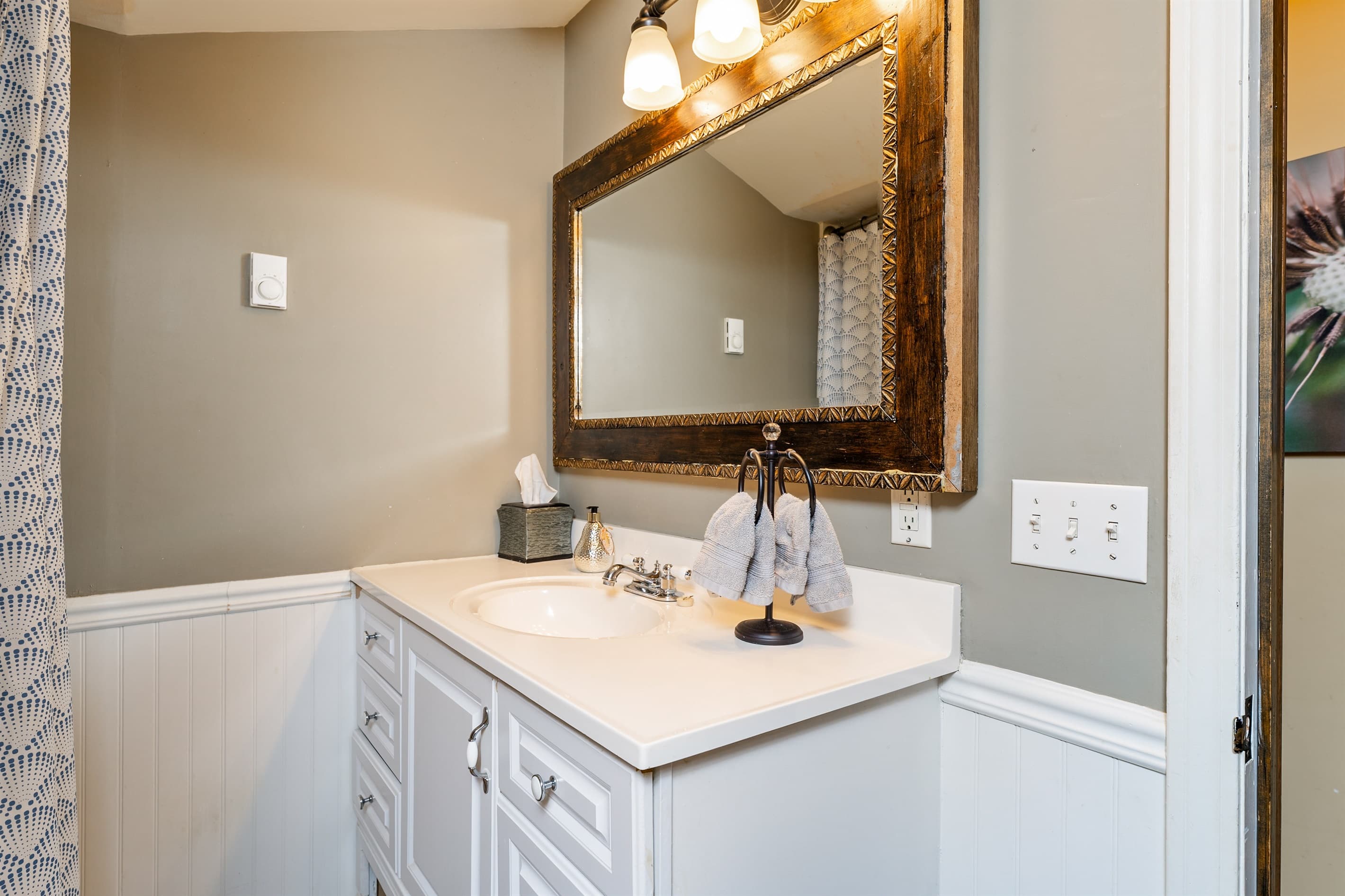 Bathroom vanity with large framed mirror