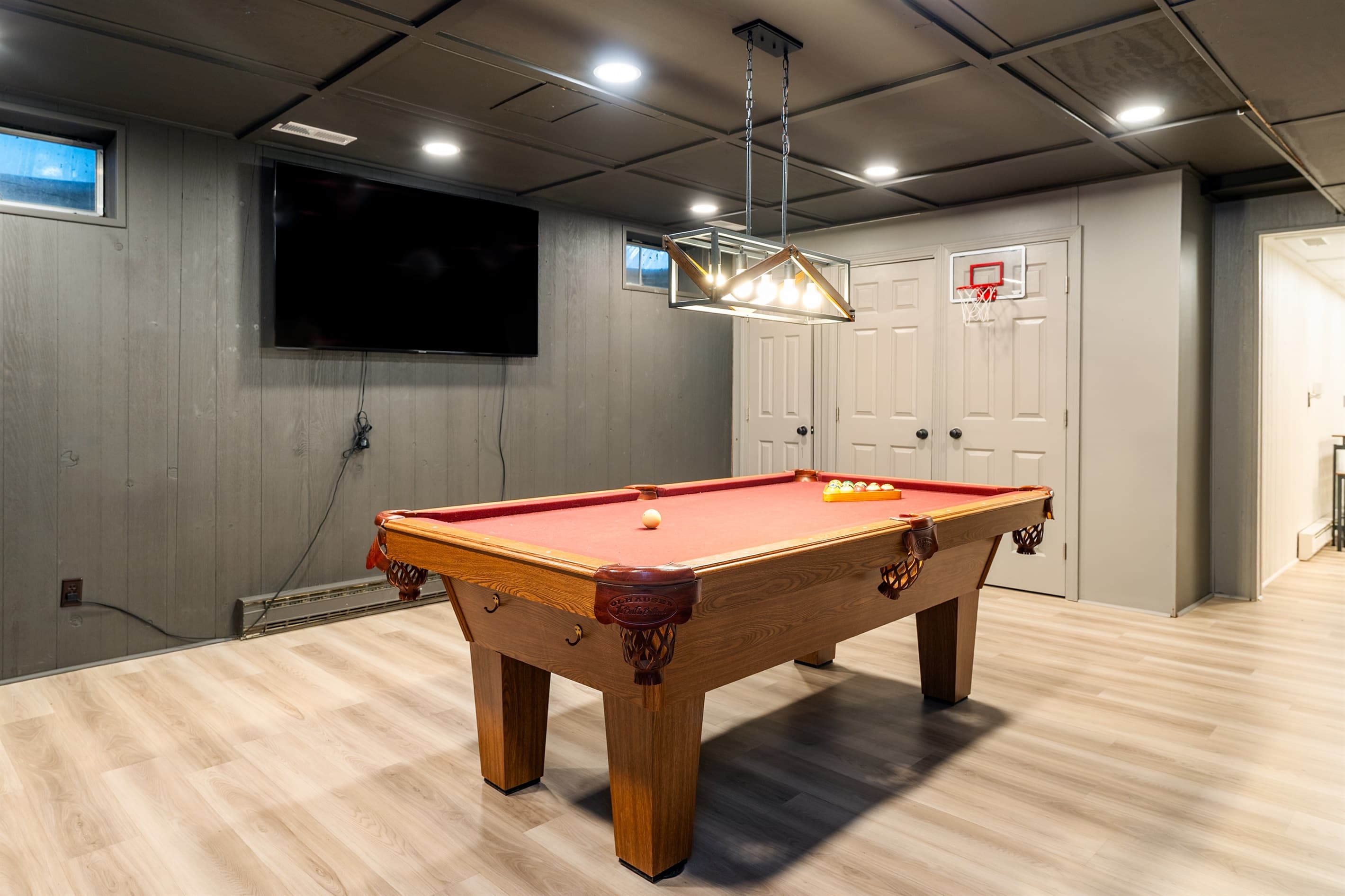 Game room with pool table and television
