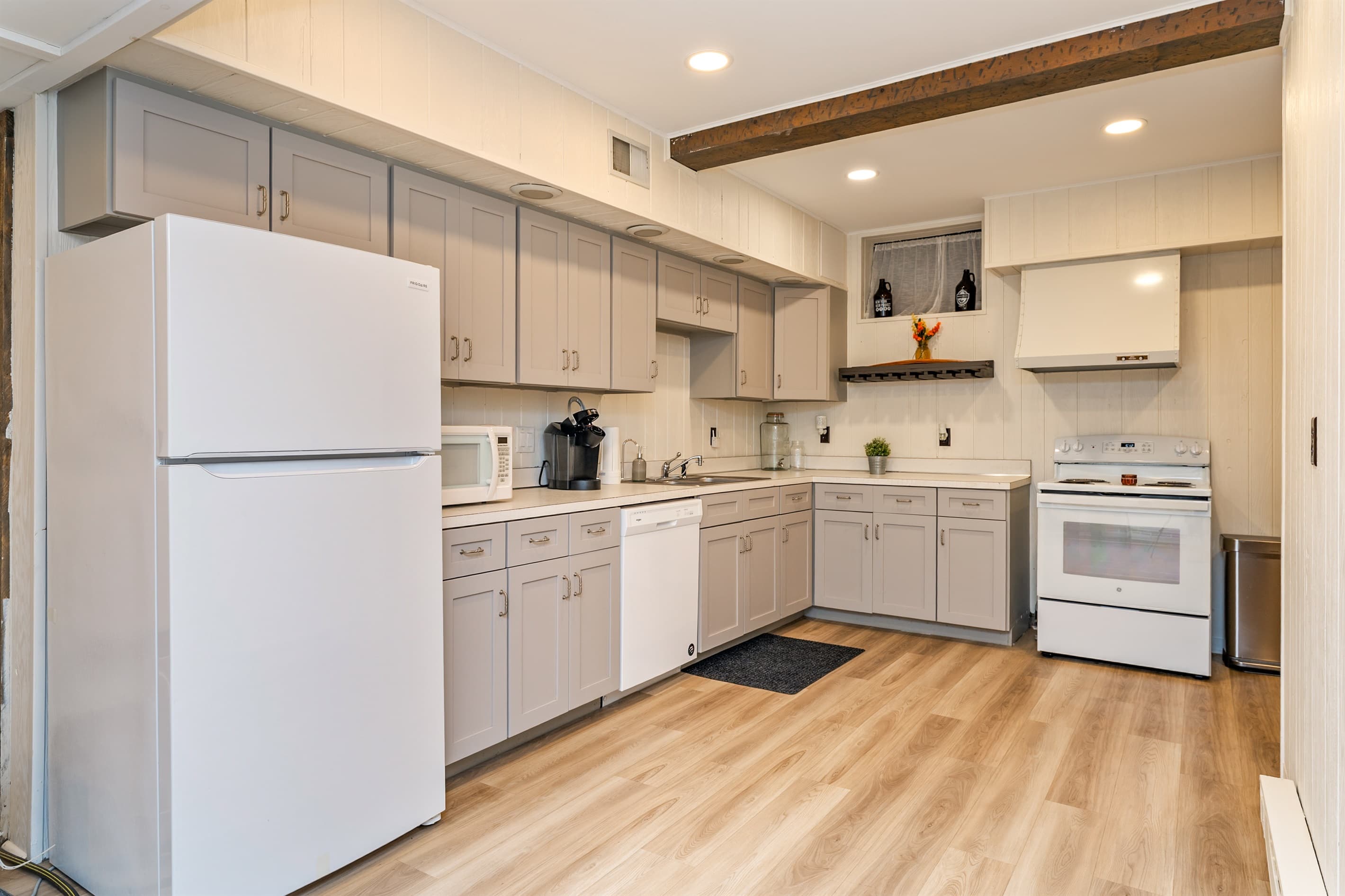 Lower-level kitchen with white cabinetry