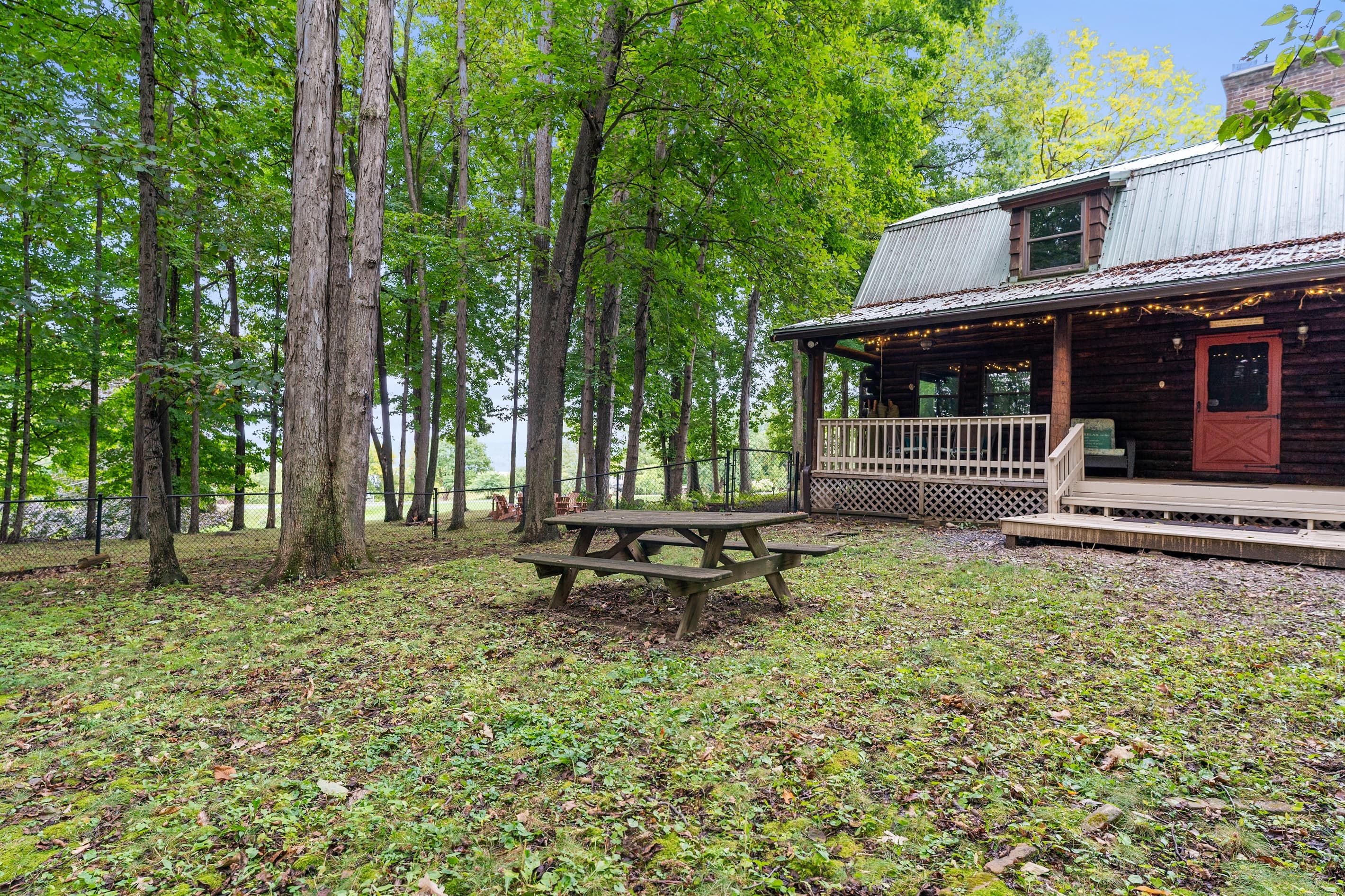 Cabin outdoor area with dining table and bench