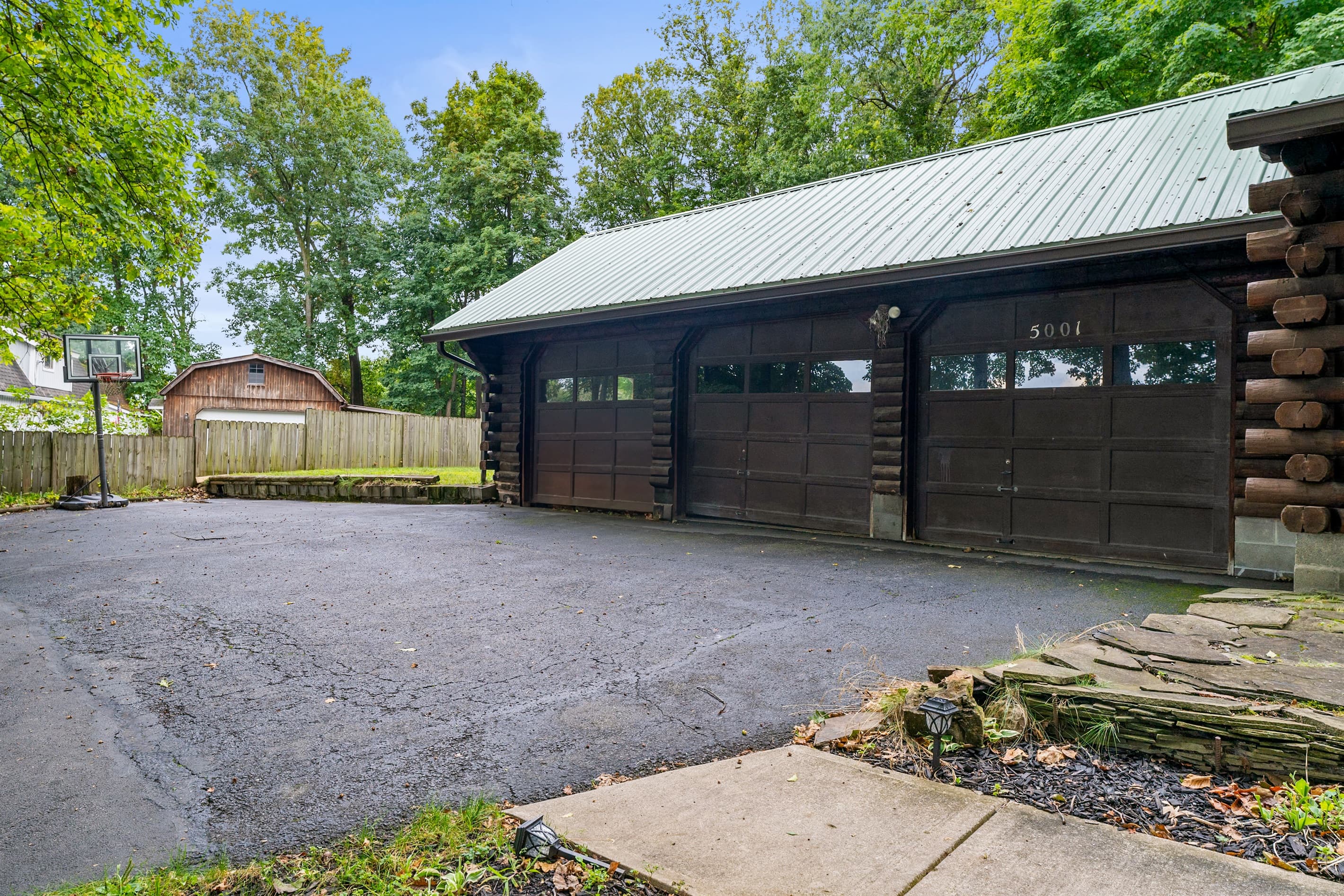Wide driveway beside the cabin and garage