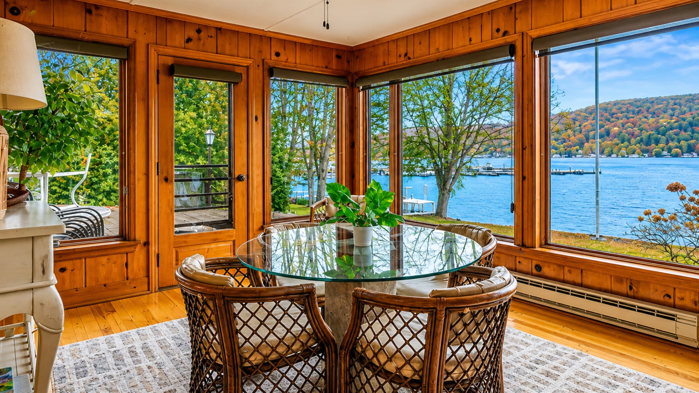 Window-lined sunroom overlooking the lake