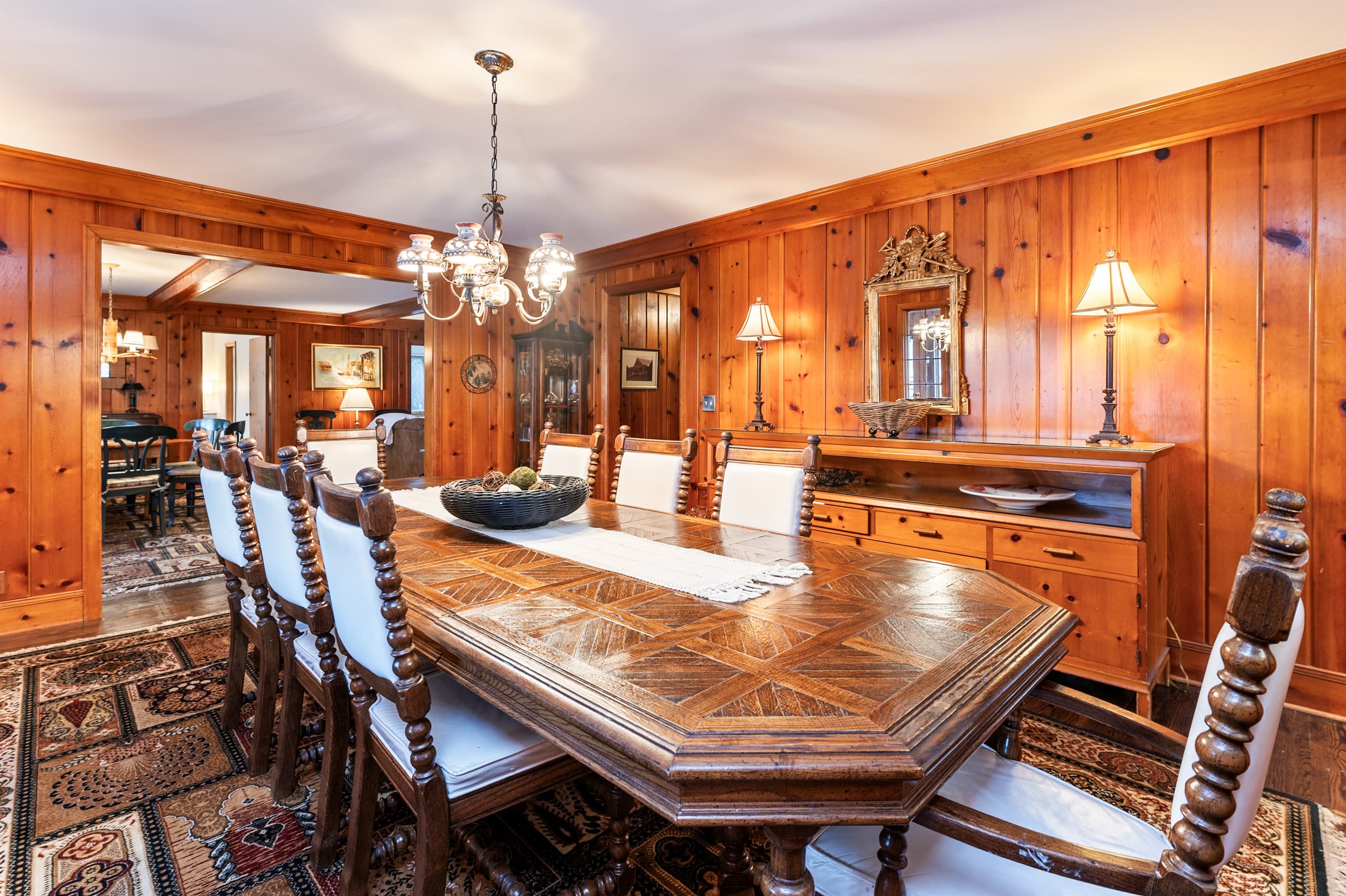 Dining table beneath warm pendant lighting