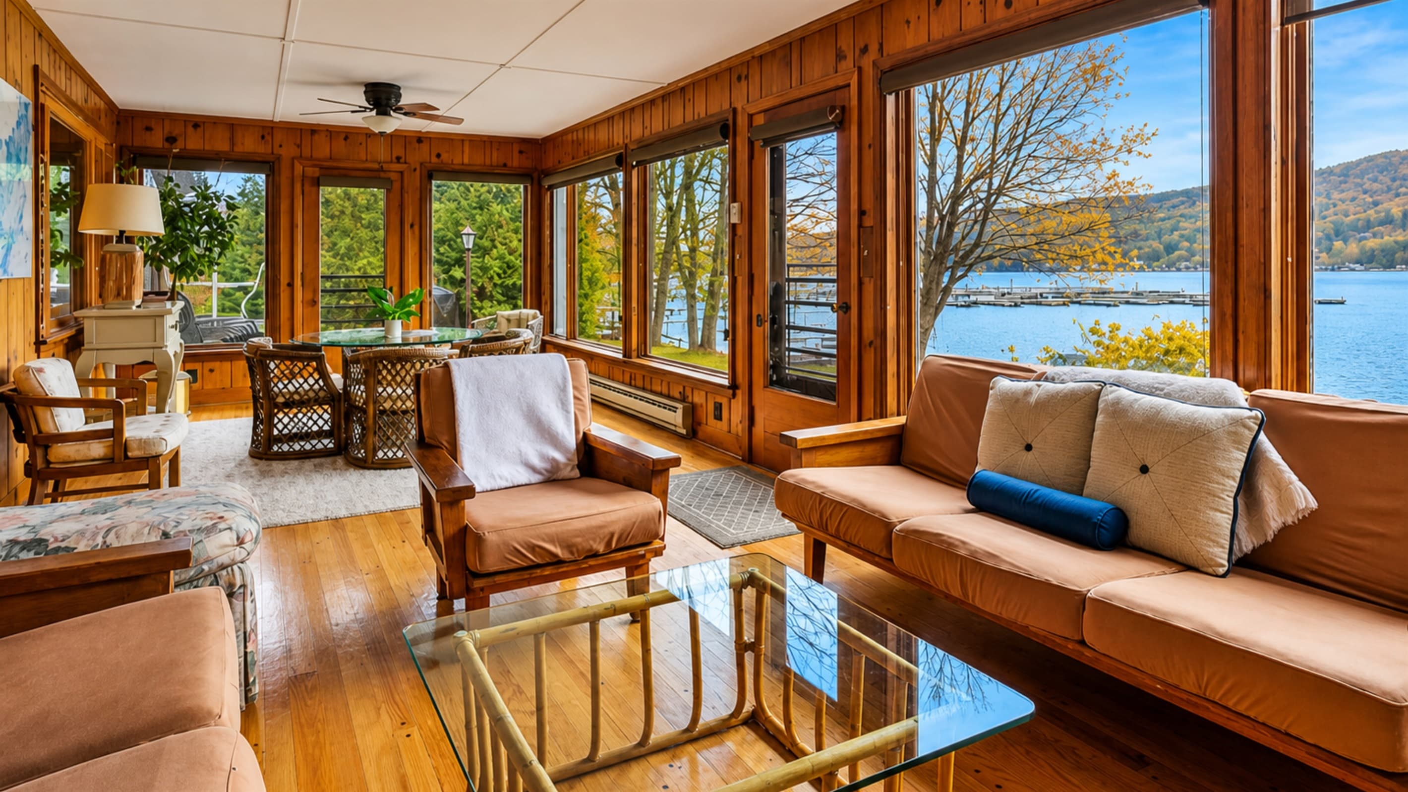 Window-lined sunroom with lake views