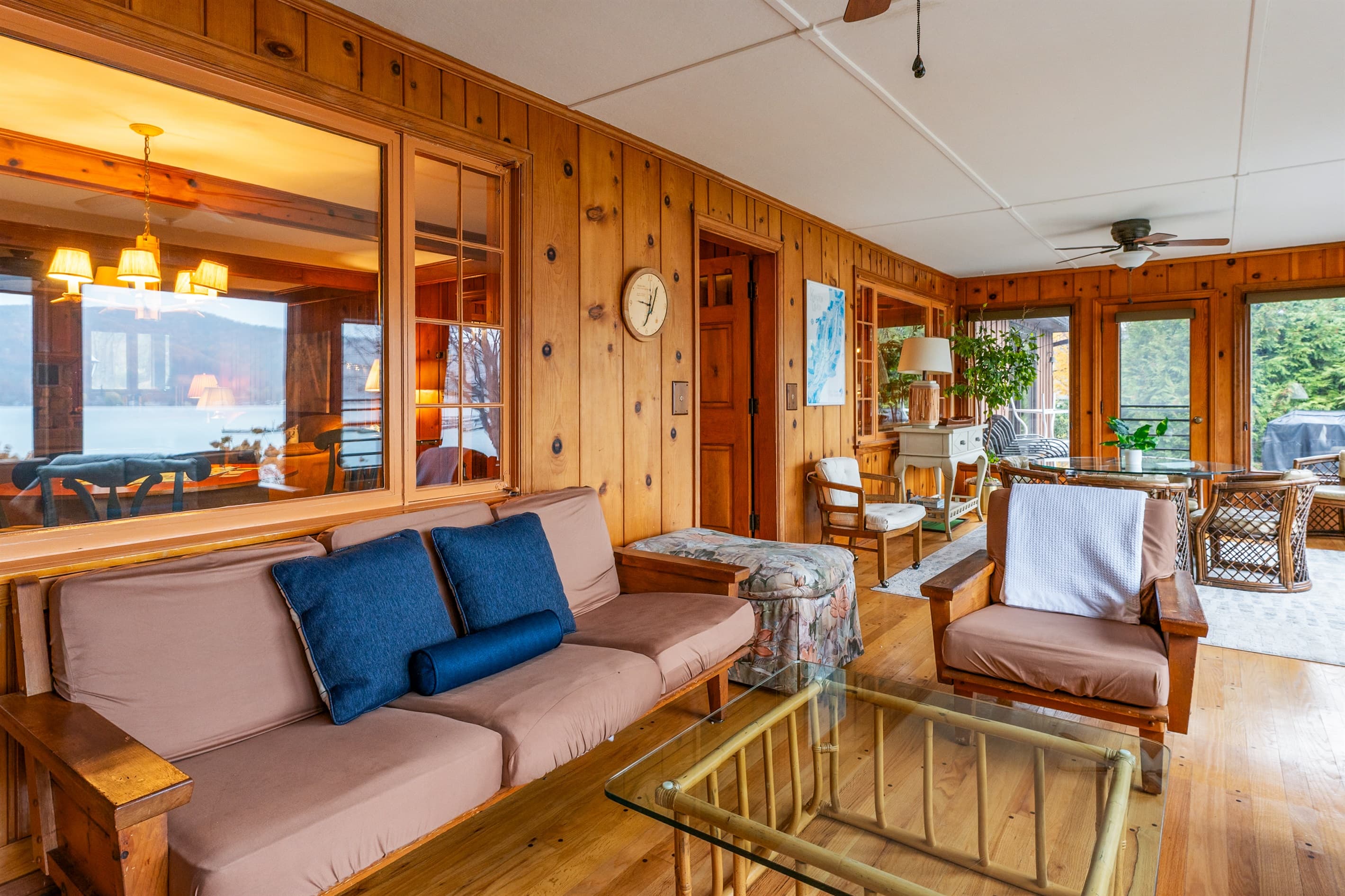 Sunroom lounge with wood-paneled walls