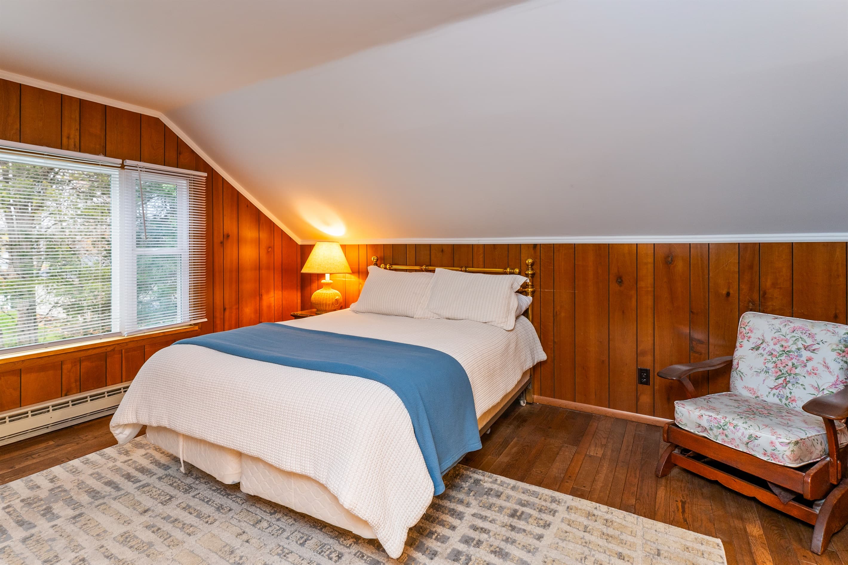 Queen bedroom with wooden armchair