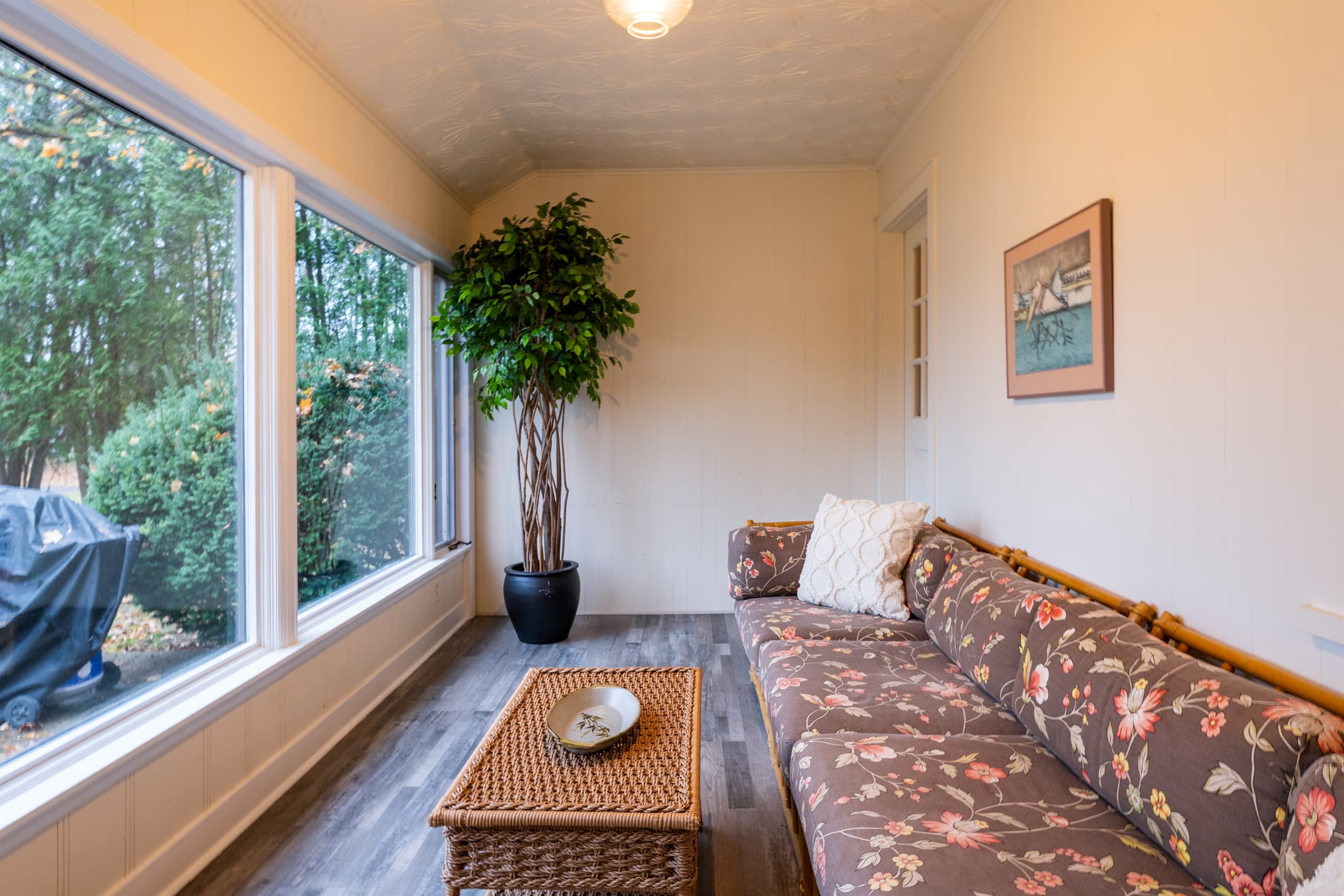 Second-home sunroom with sofa and large windows