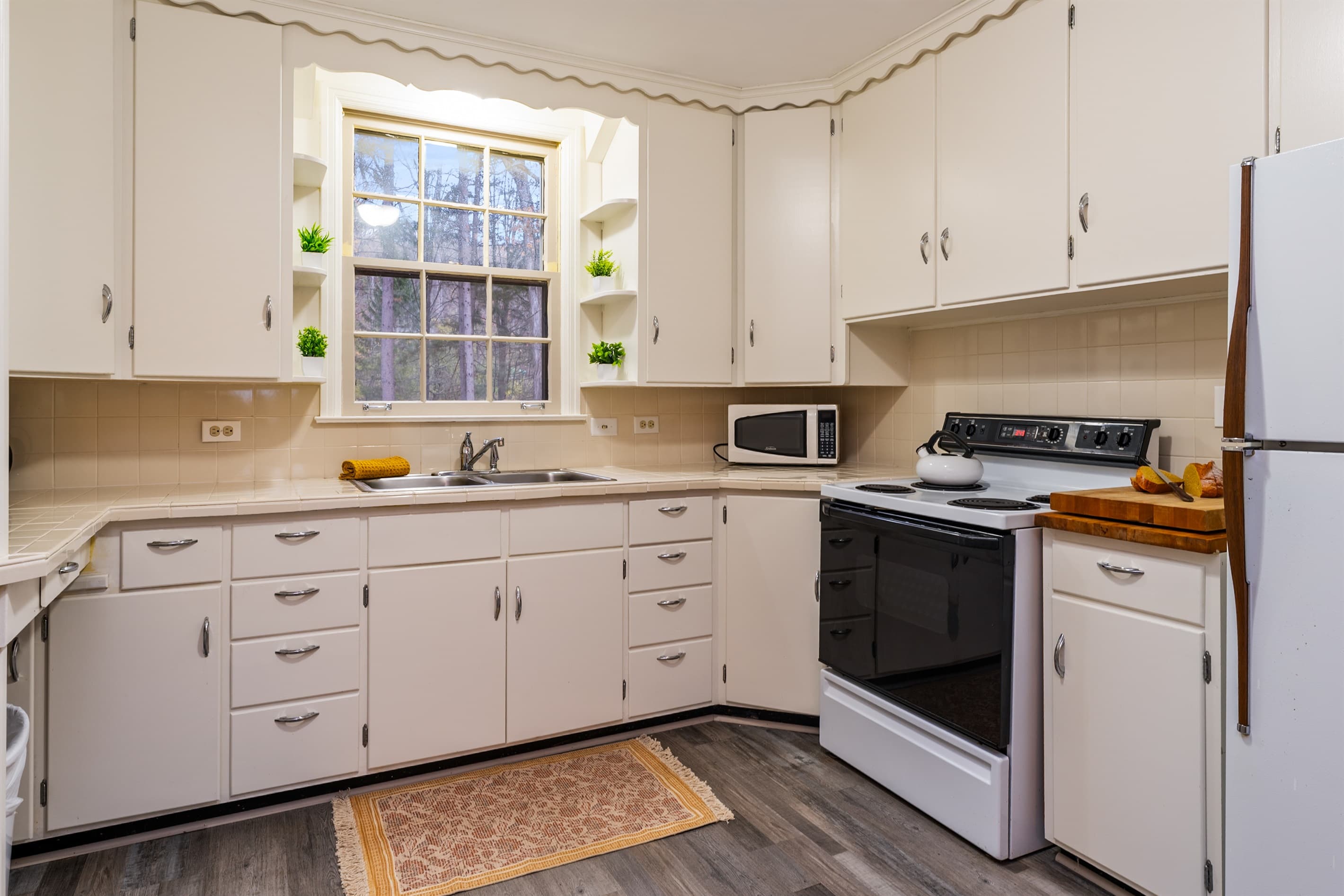 Kitchen with white cabinetry and ample storage
