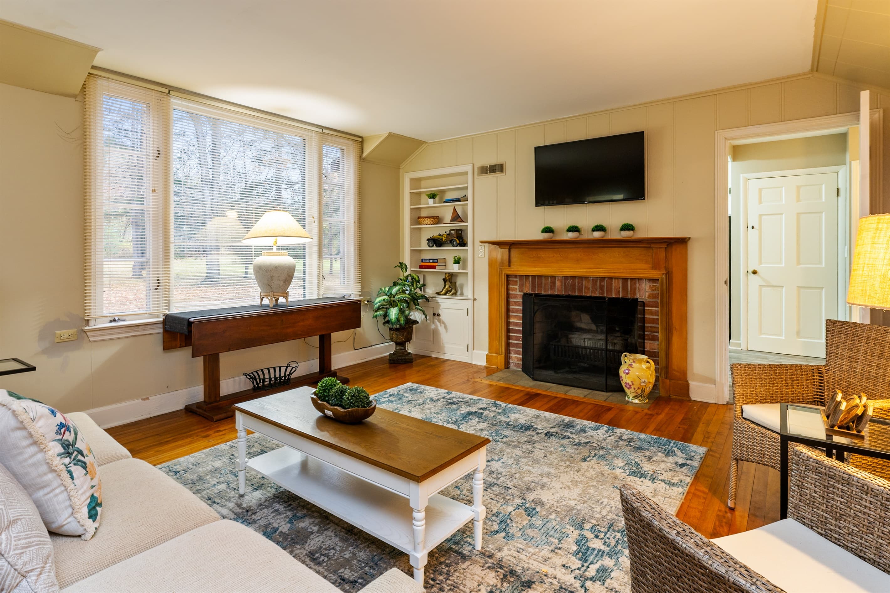 Bright living area with fireplace and sectional (fireplace is not for guest use)