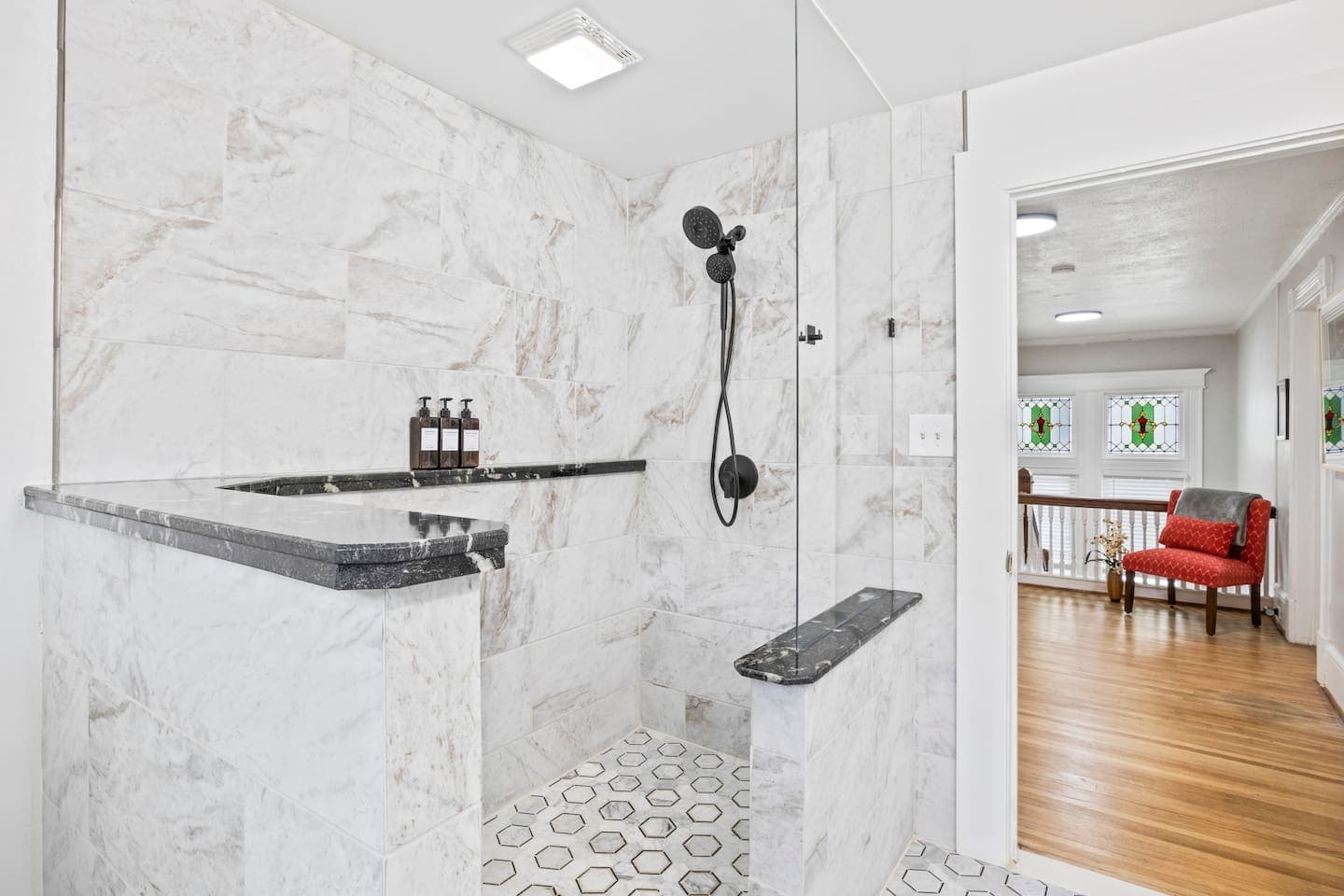Walk-in shower with marble-patterned tile