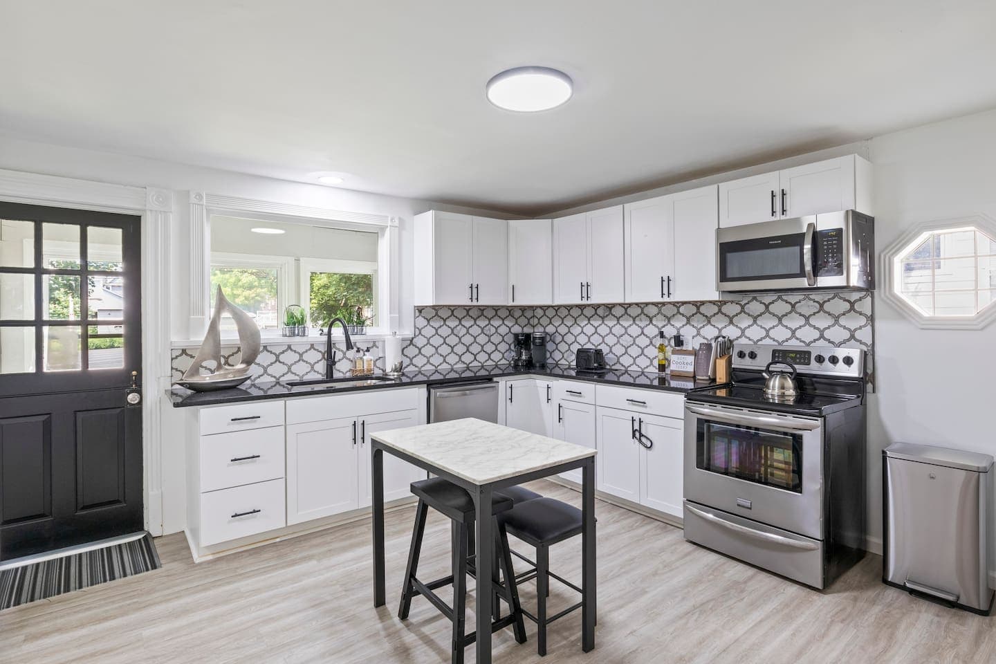 Kitchen with marble-patterned backsplash and island seating