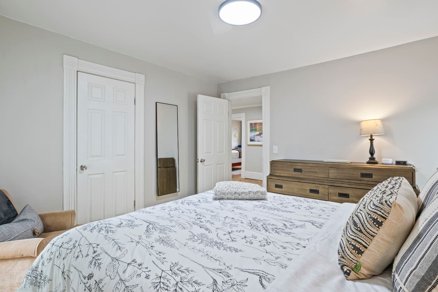 Bedroom with dresser and adjoining doorway