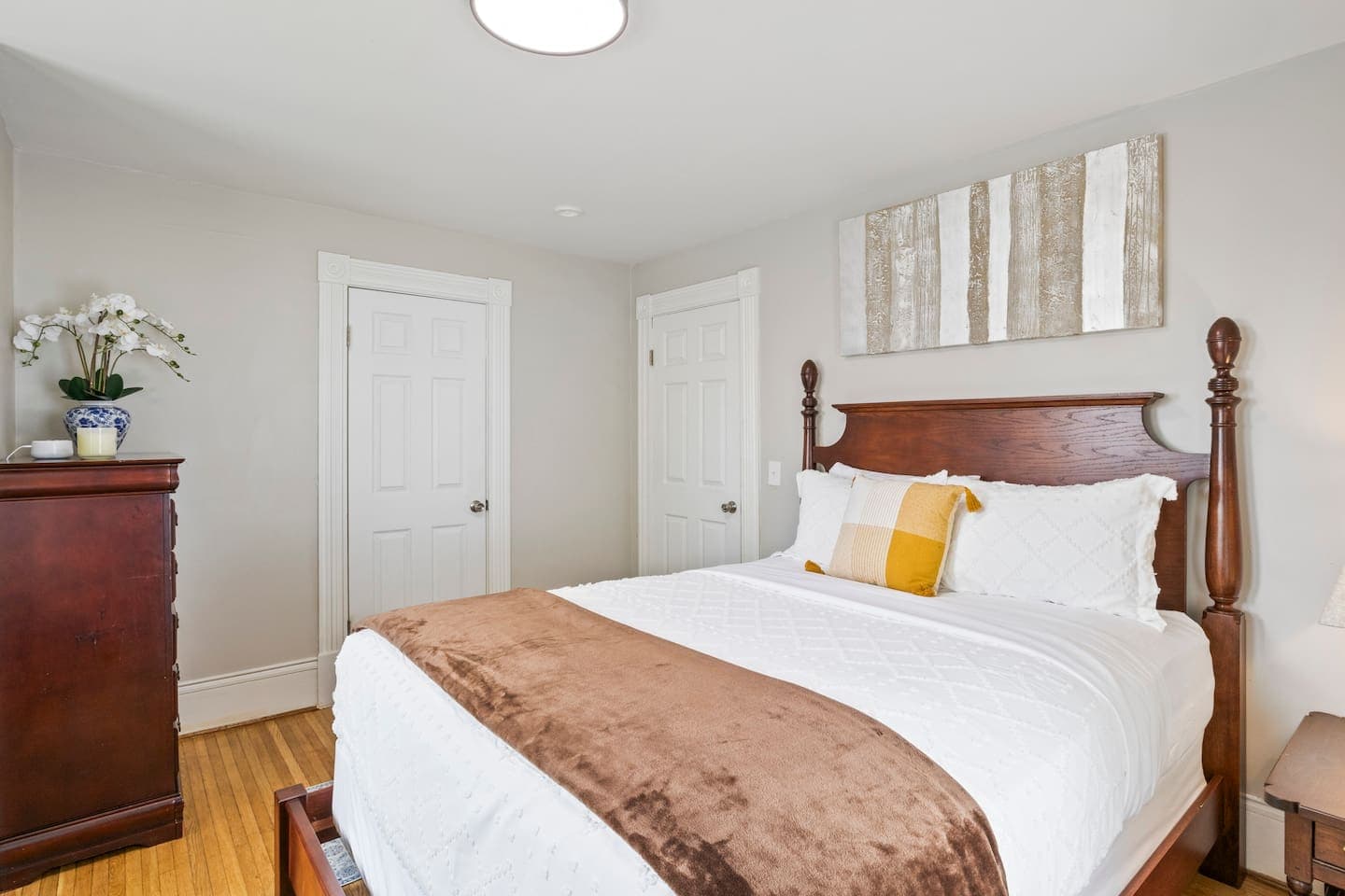 Traditional wood bed with neutral bedding