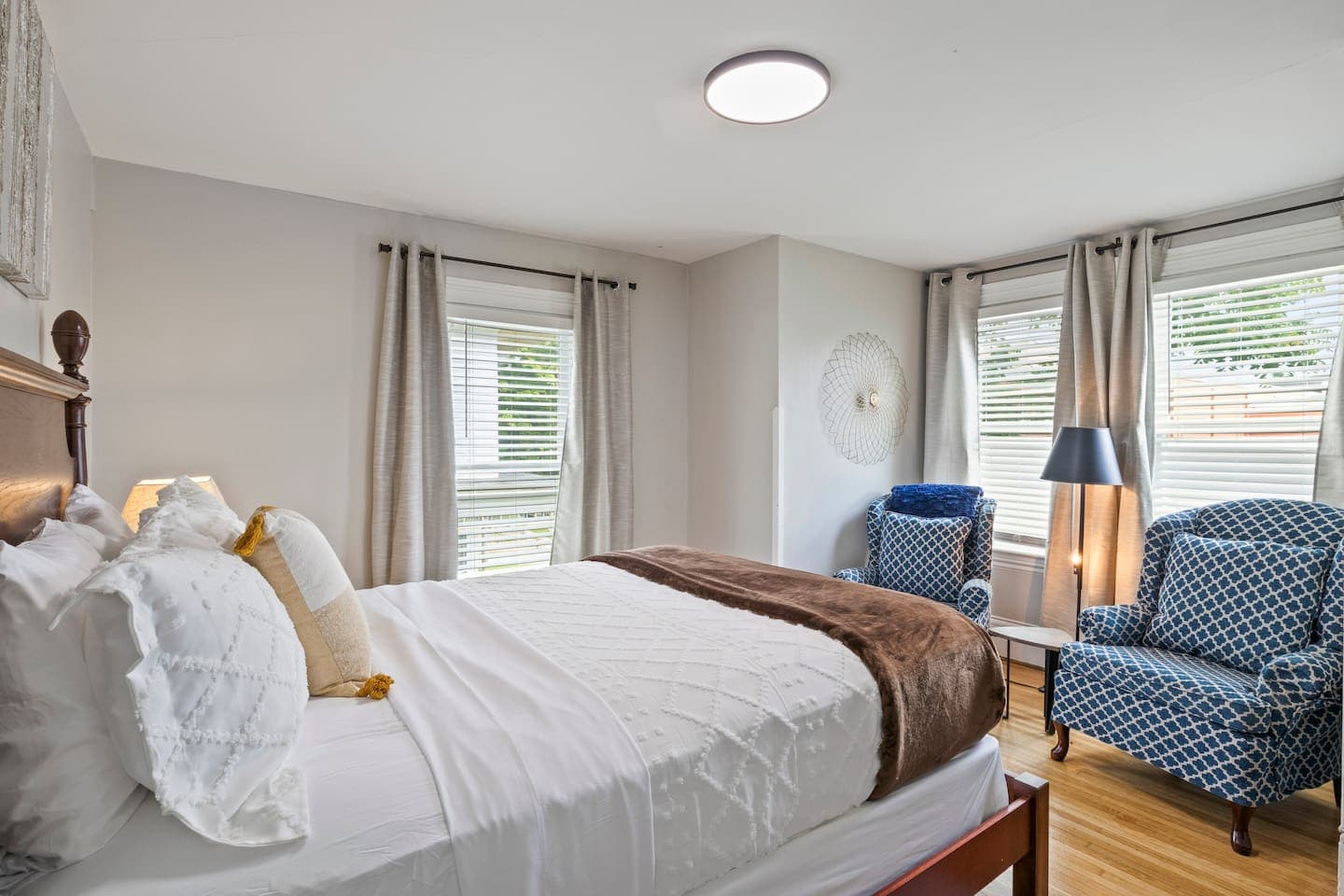 Bedroom sitting area beside corner windows