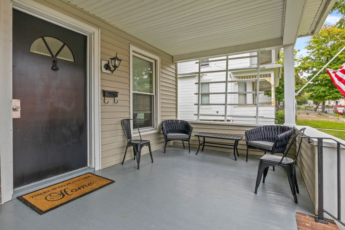 Covered front porch with bench and chairs