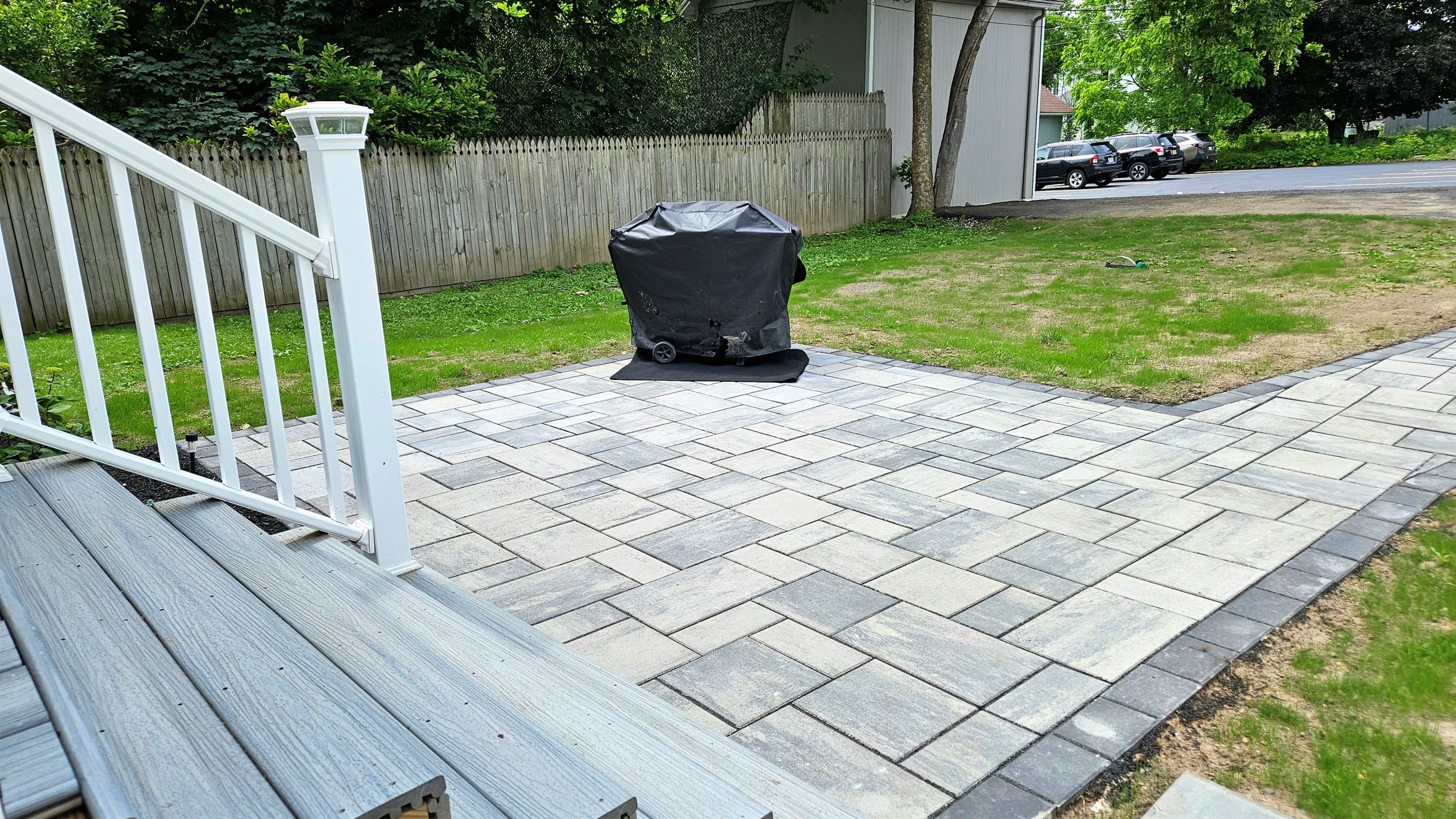 Paved backyard patio with grill