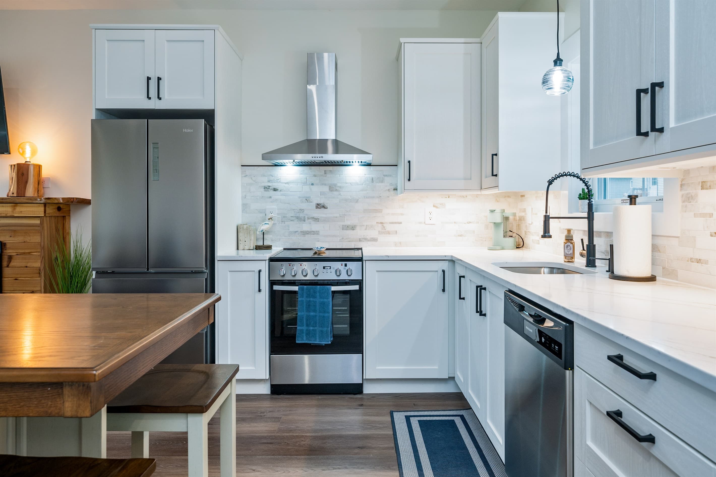 Kitchen with stainless-steel appliances and range hood