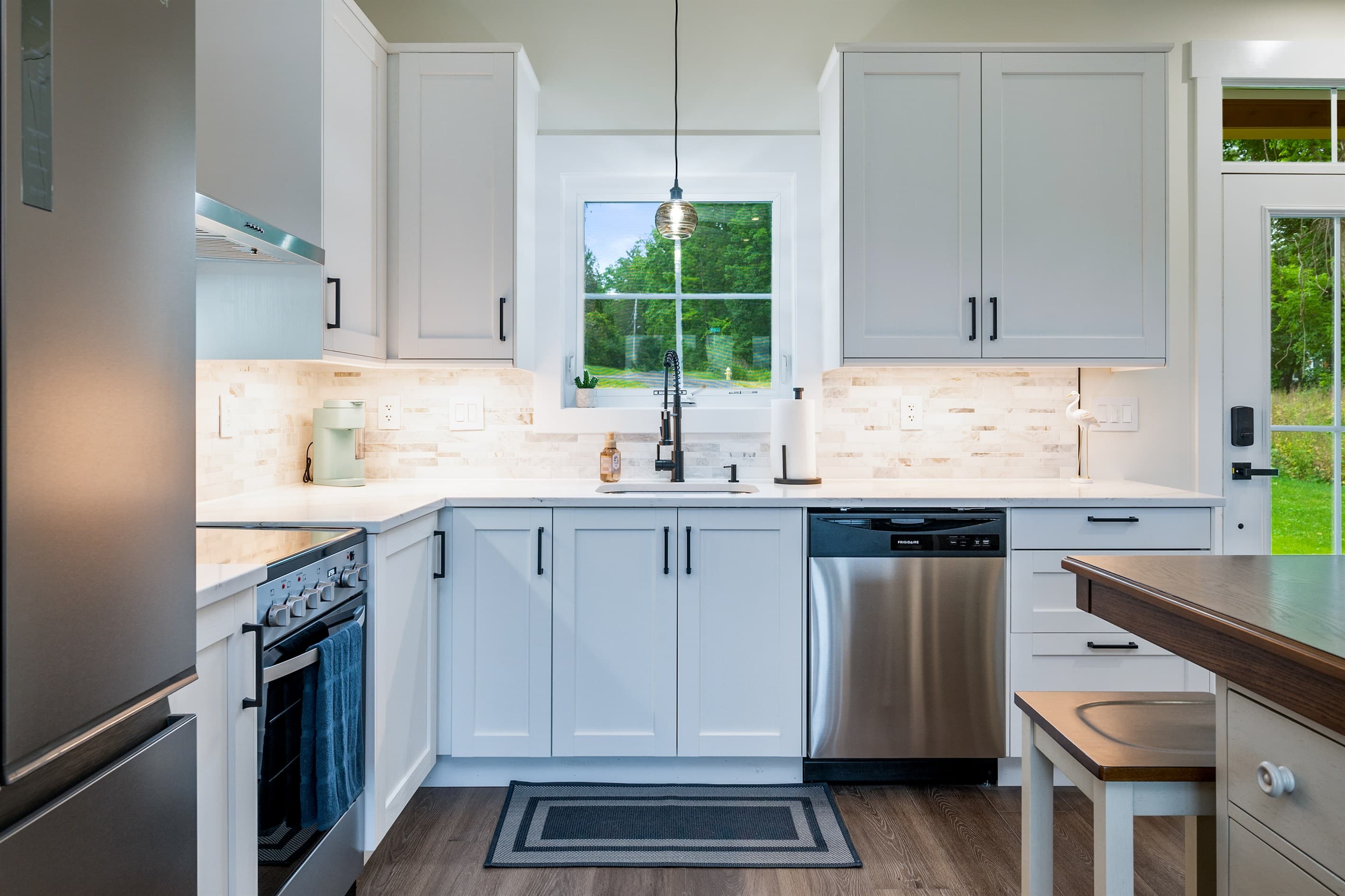 Kitchen with gray cabinetry and ample counters
