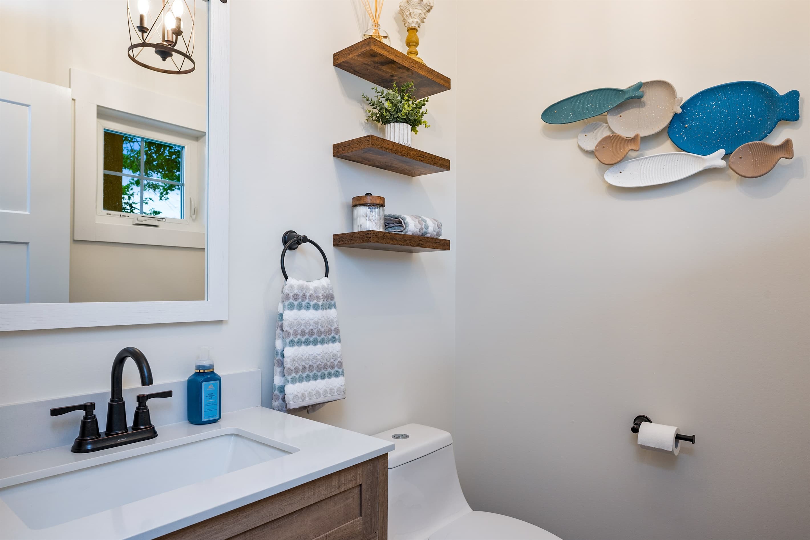 Bathroom with sink, toilet and floating shelves