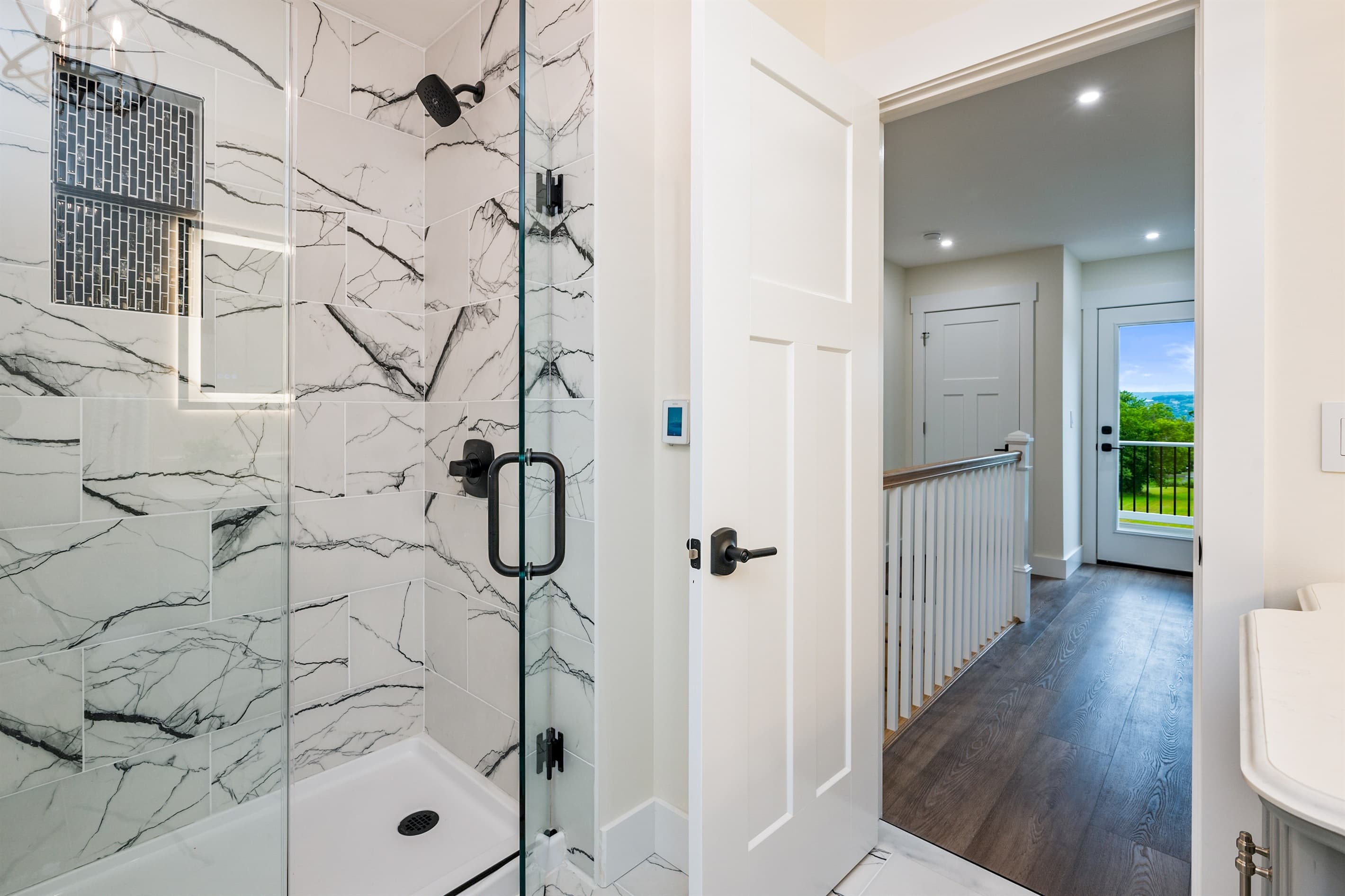 Walk-in shower with marble-patterned tile