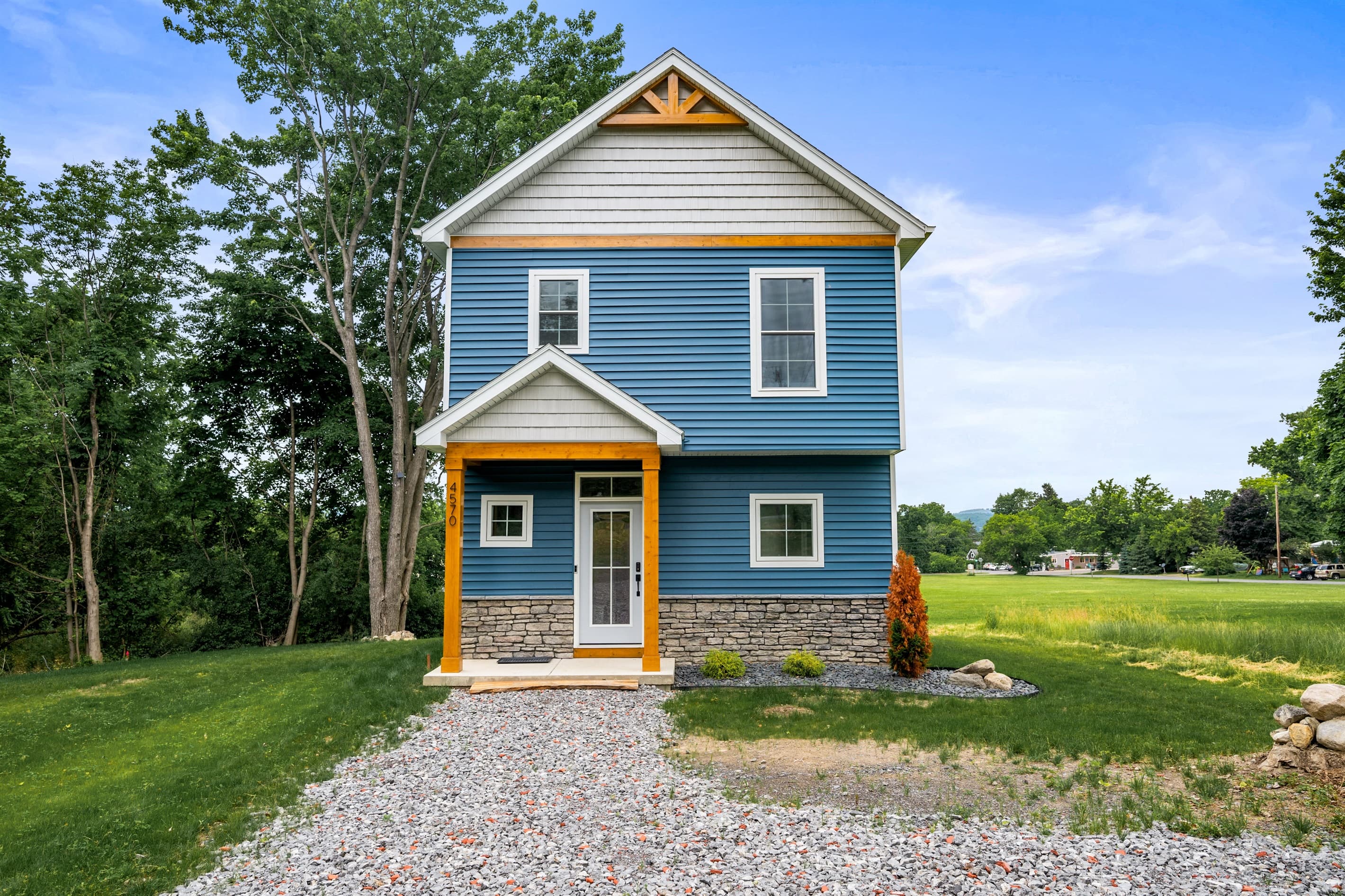 Front exterior with gravel driveway
