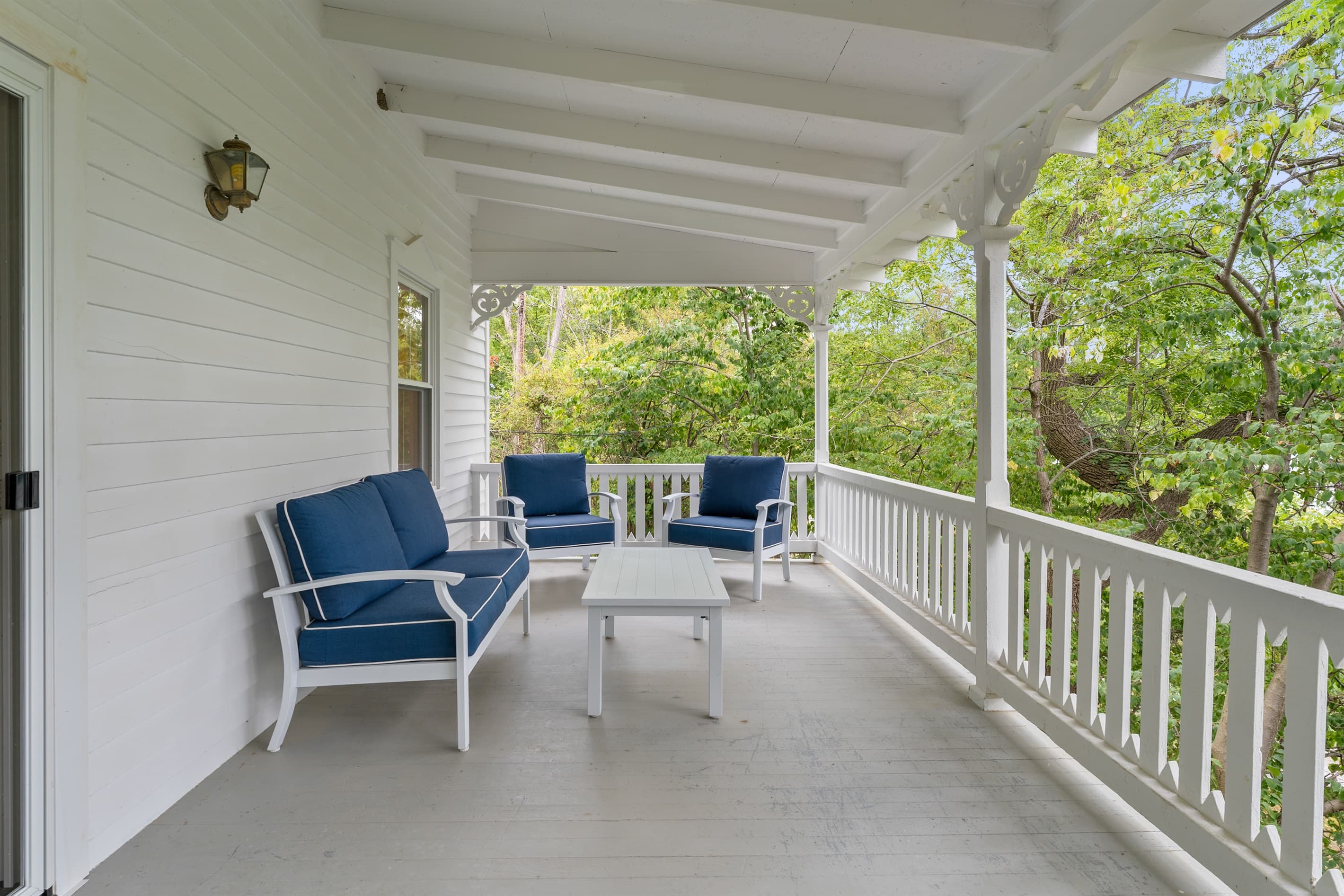 Covered porch with seating and wooded views