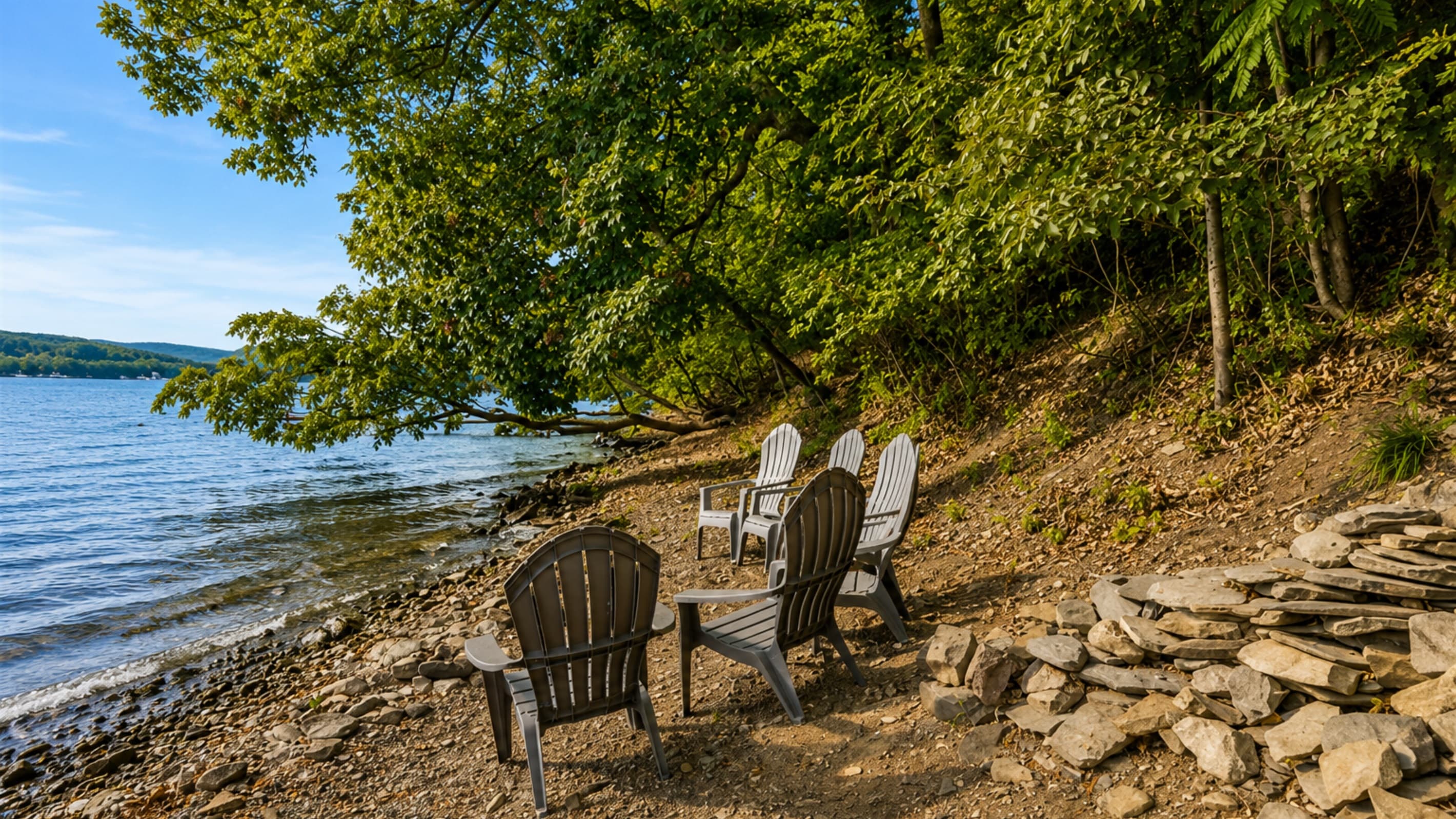 Adirondack chairs beside the water