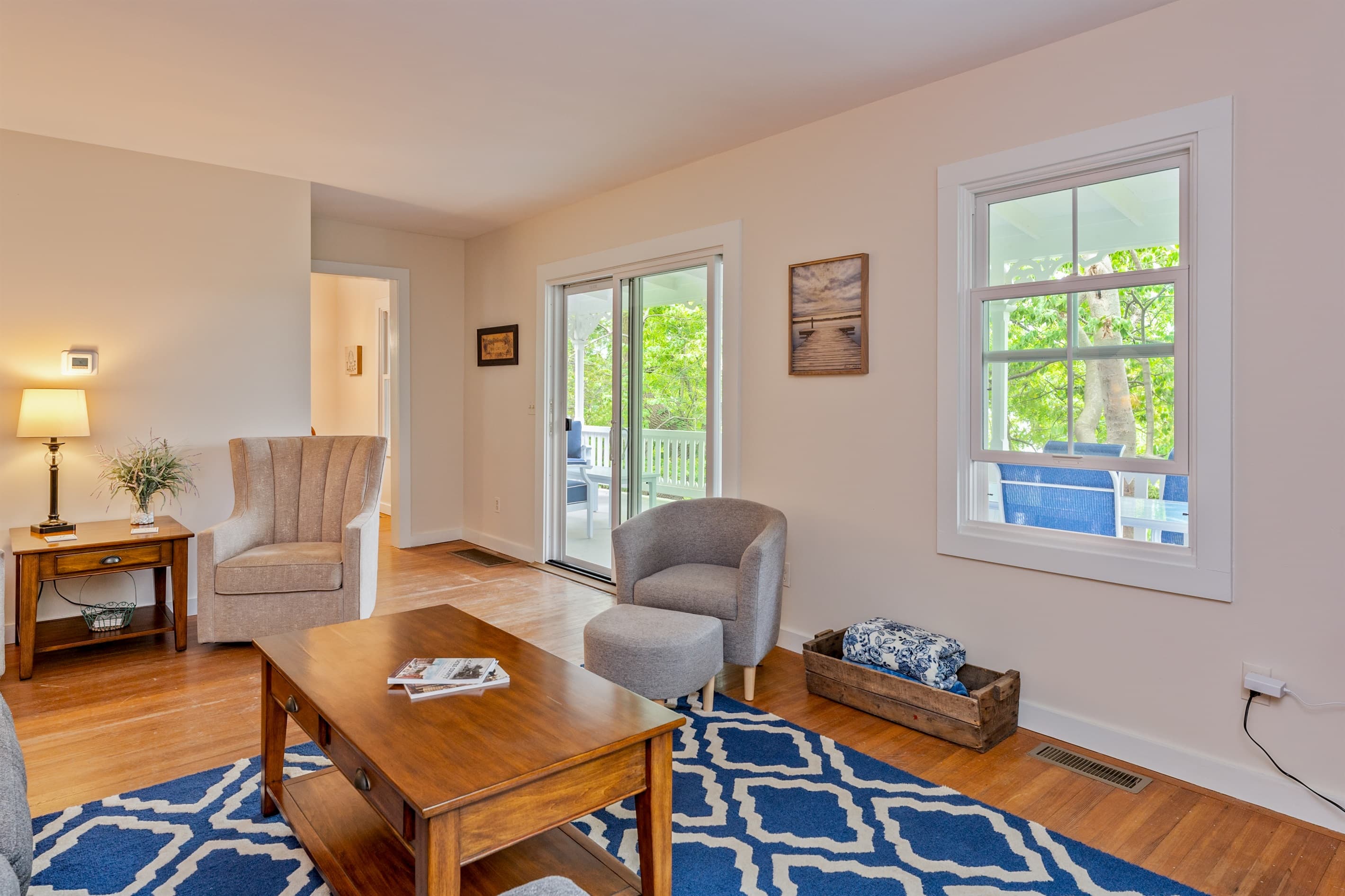 Living area with armchairs and wooden tables