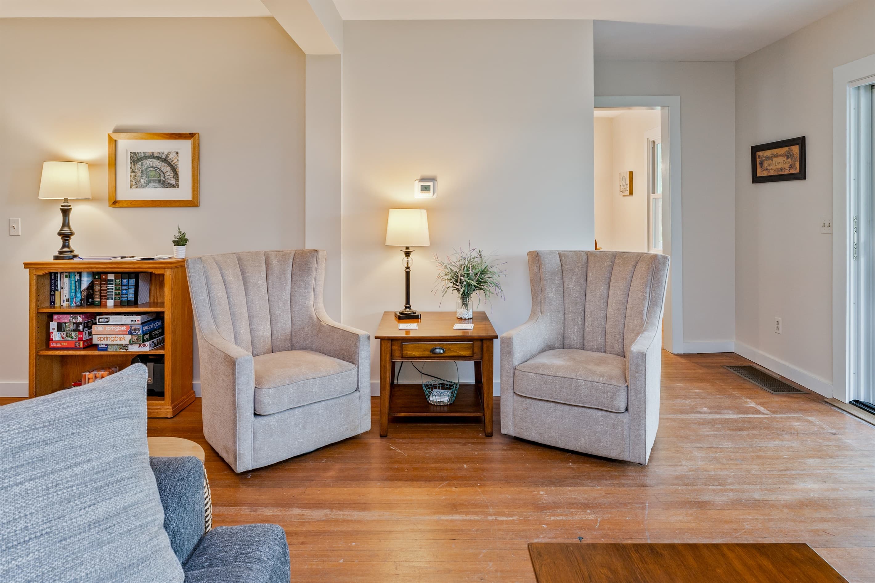 Sitting area with armchairs and bookcase