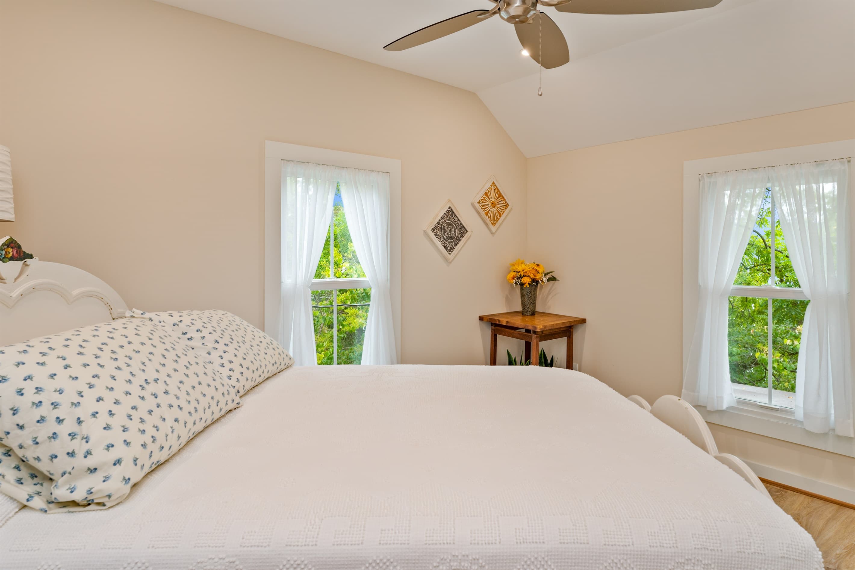 Sunlit bedroom with windows on two walls