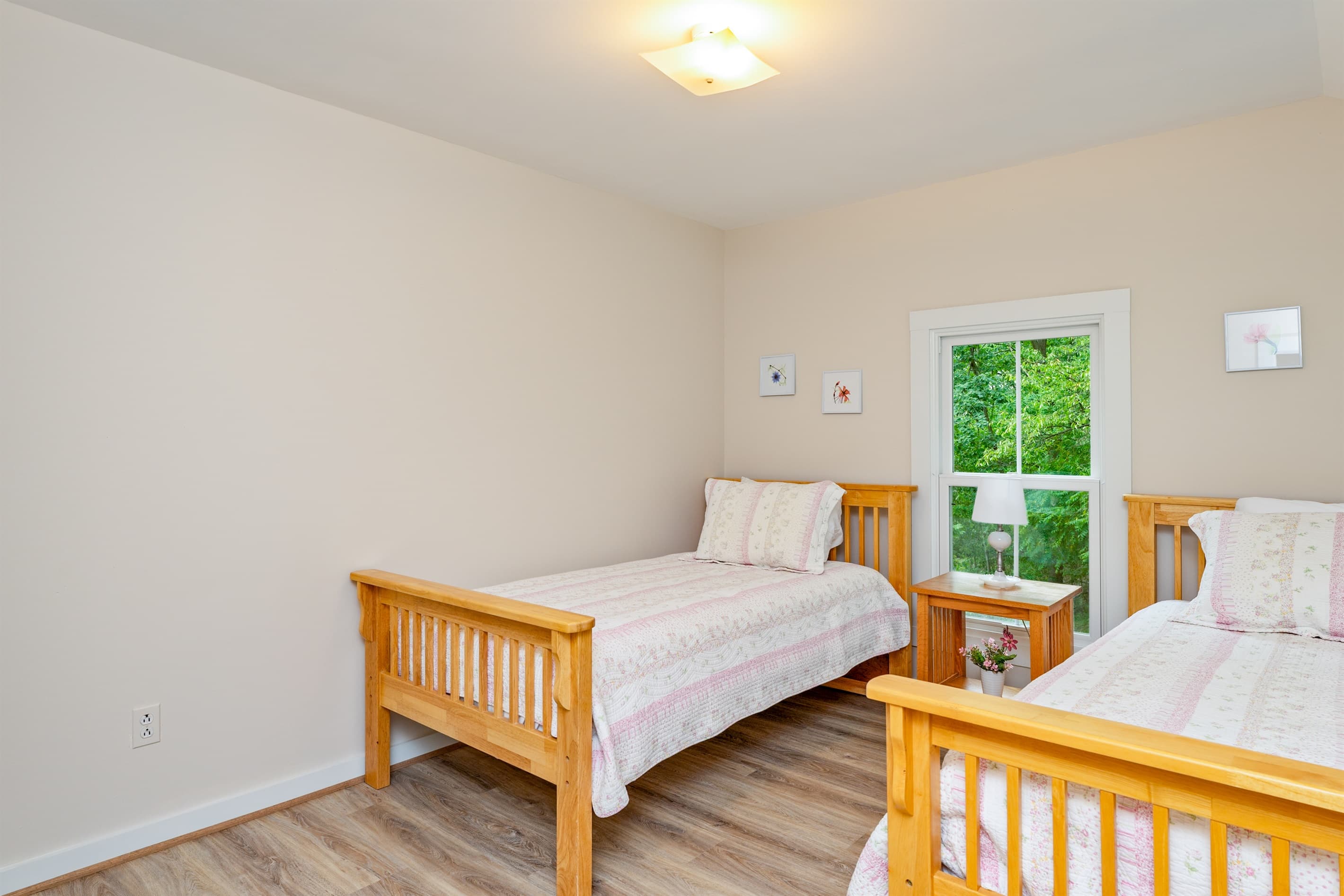 Twin bedroom with two wood-framed beds