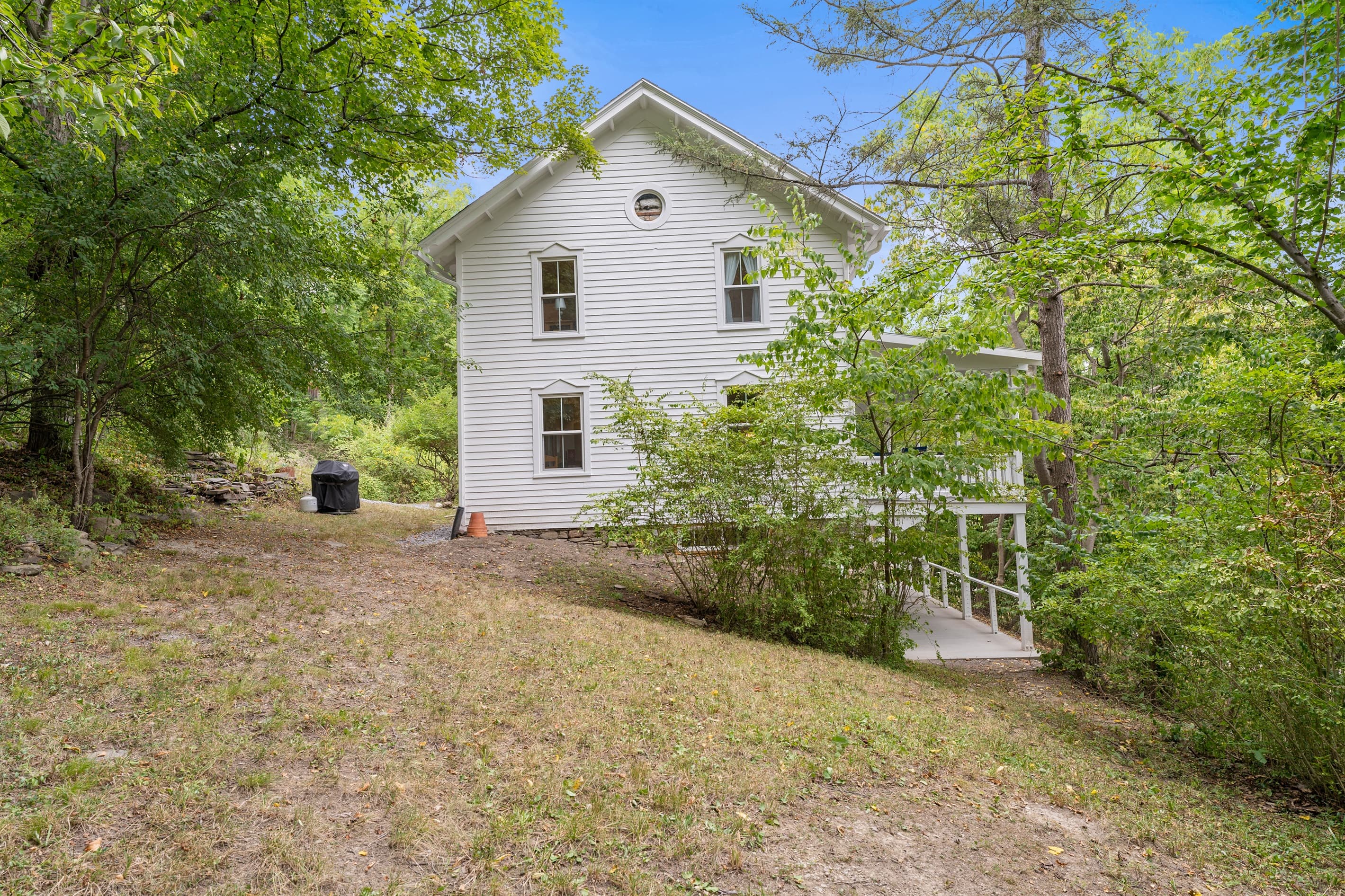 Side exterior with wooded surroundings