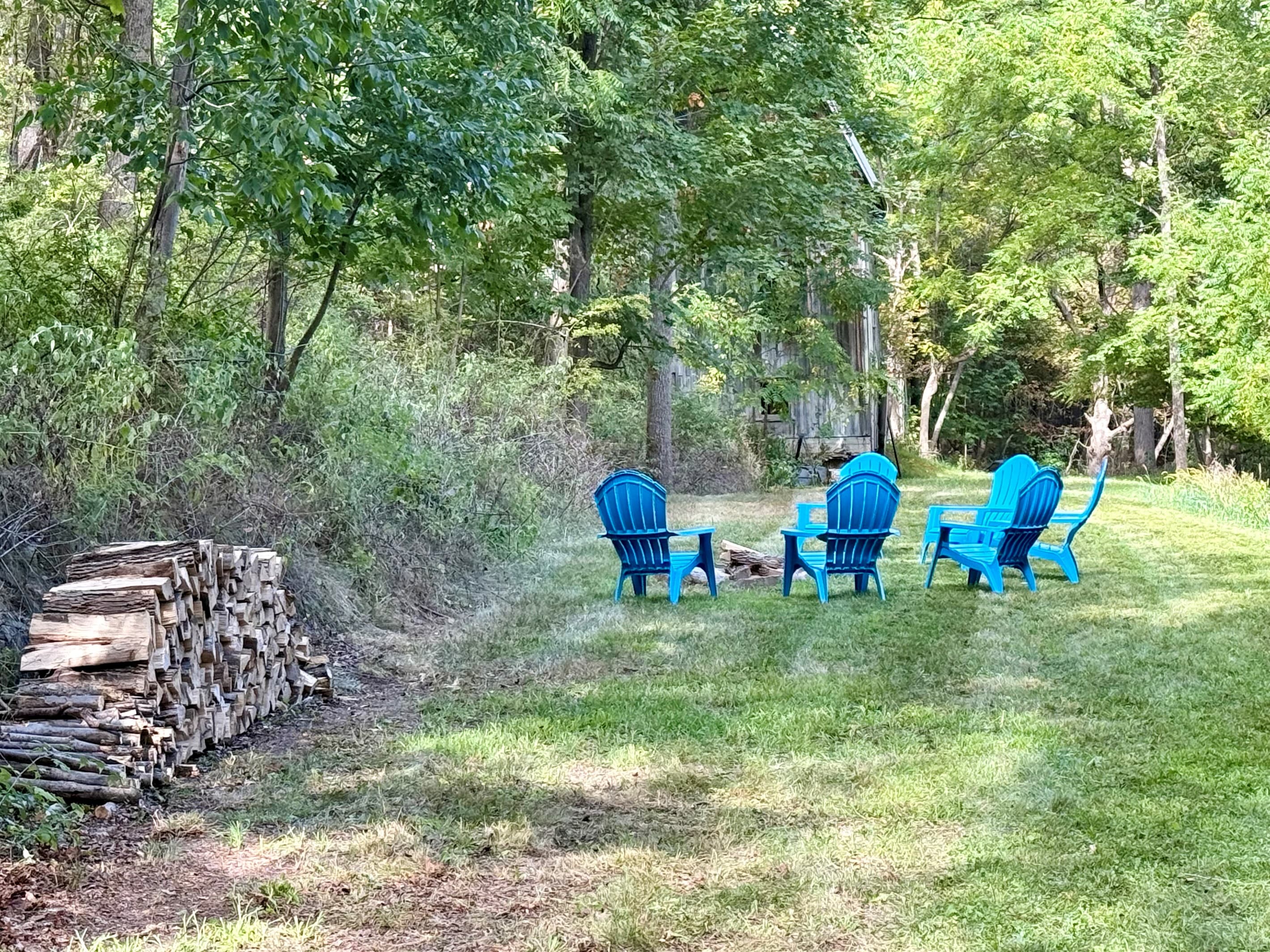 Upper fire pit area with Adirondack chairs