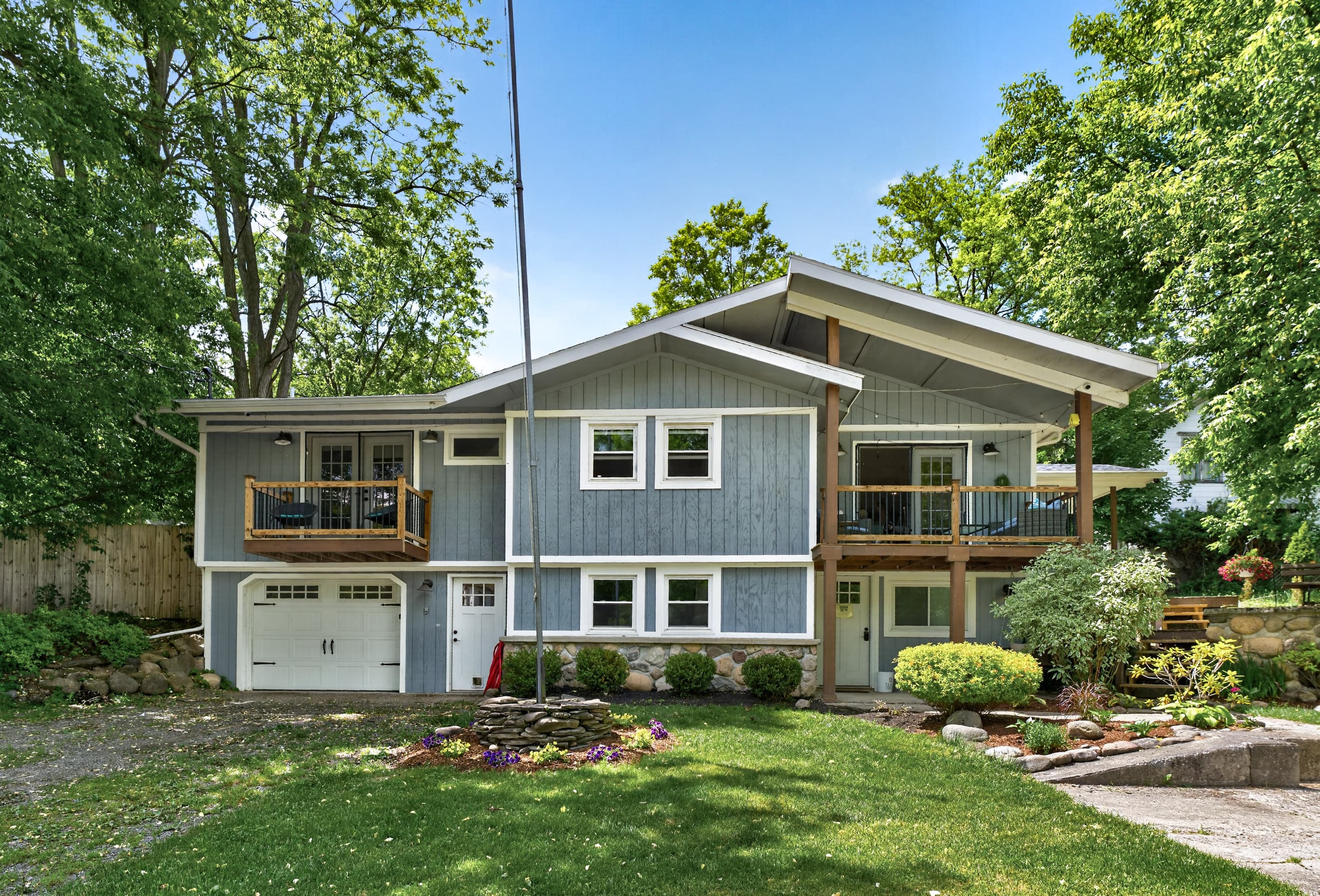 Rear exterior with upper deck and lower patio