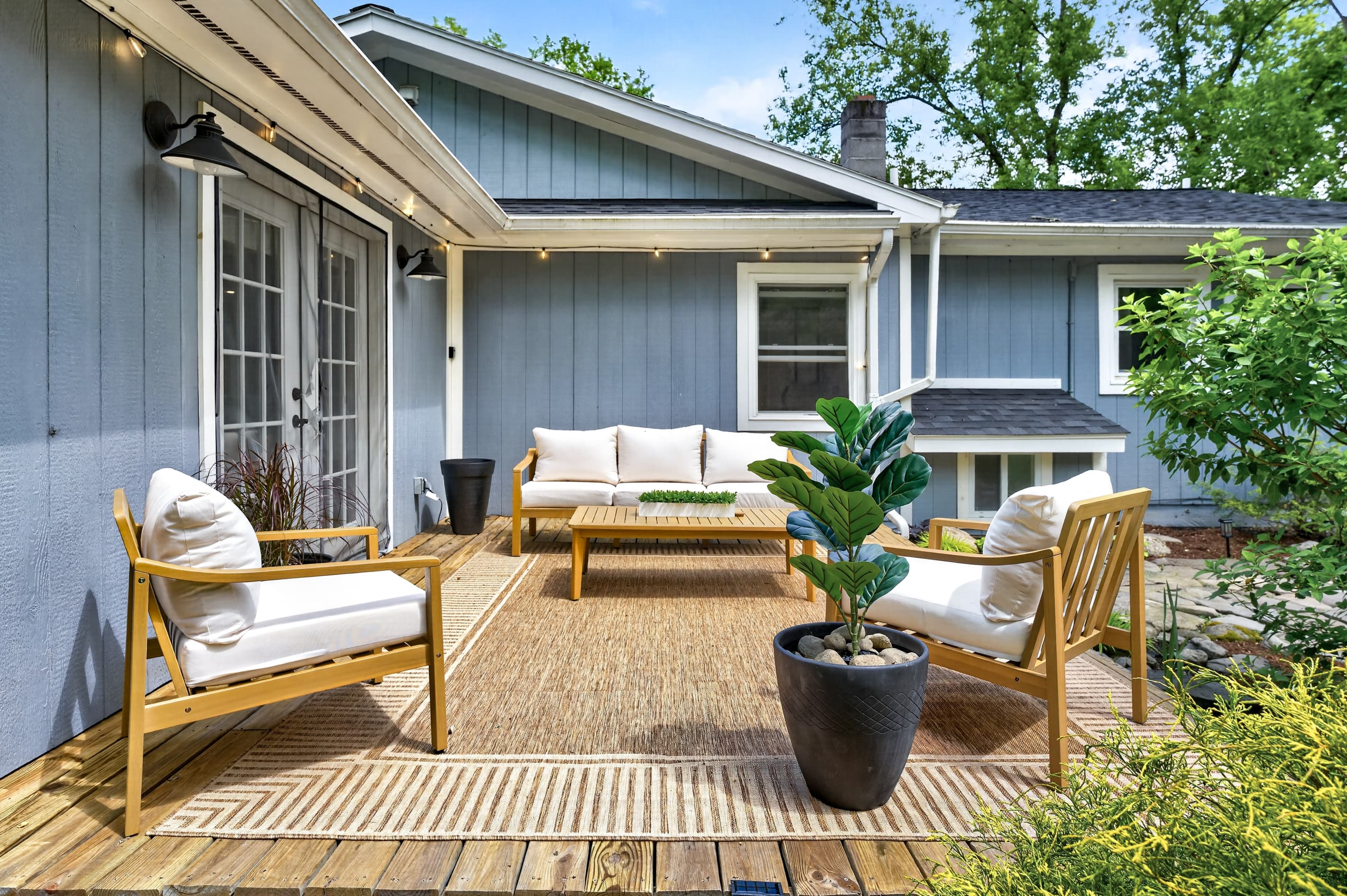 Patio lounge arranged around a potted plant