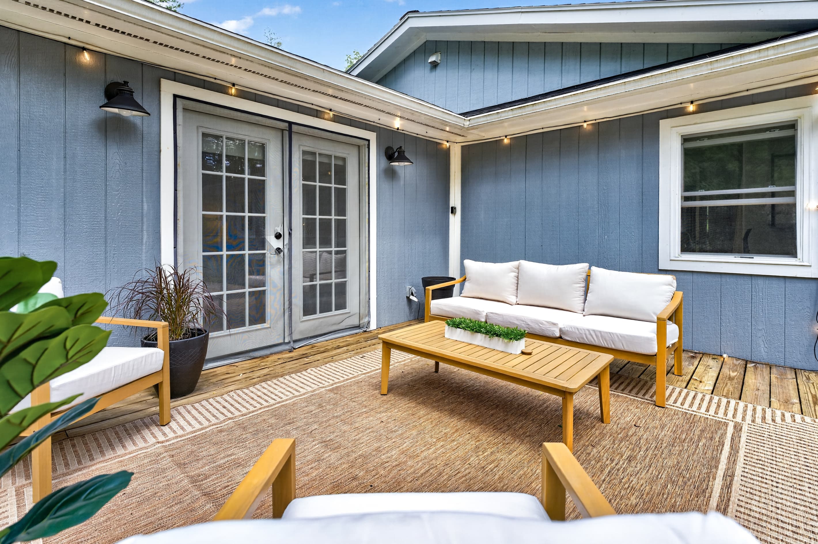 Patio seating against blue exterior walls