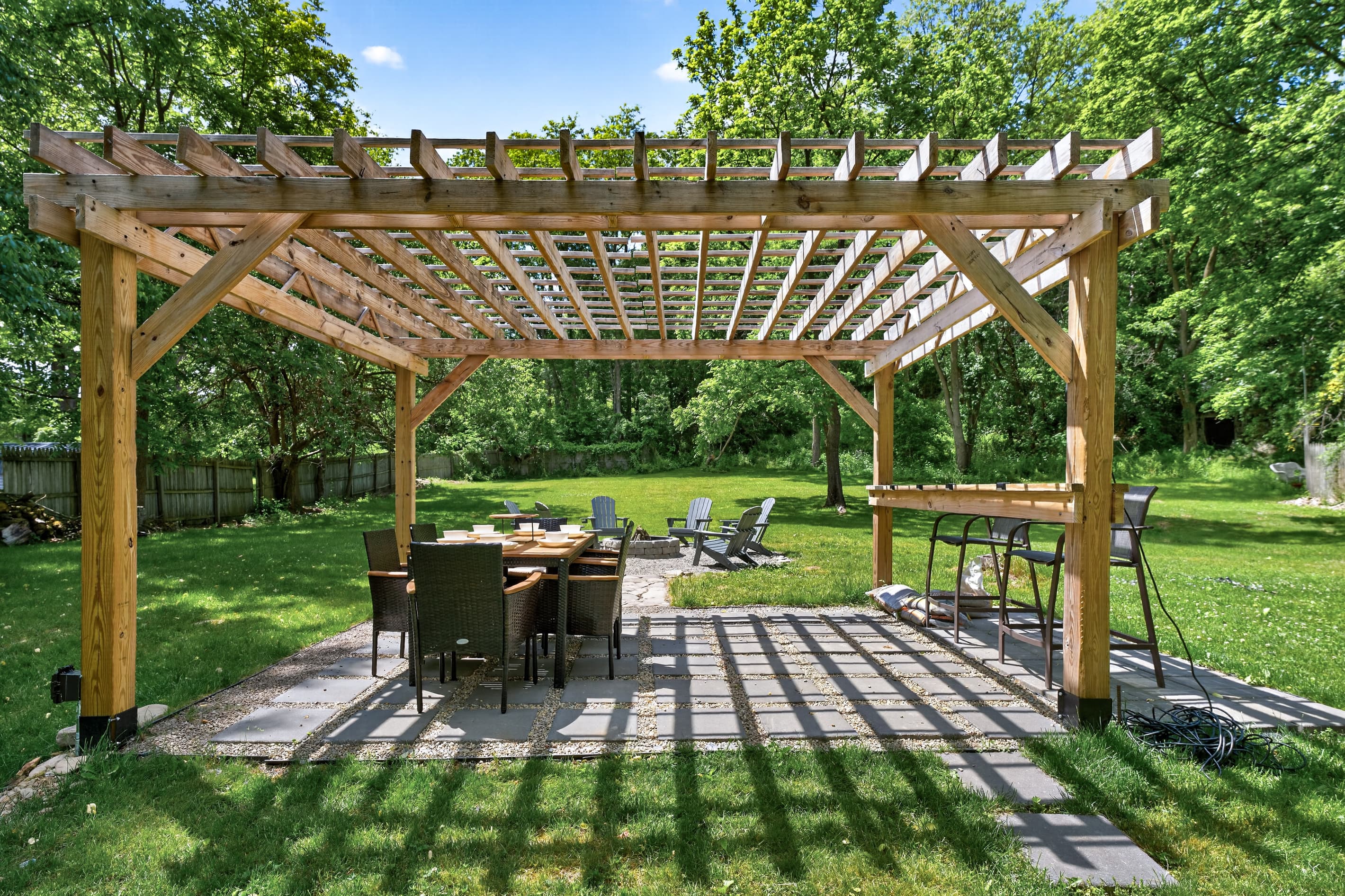 Pergola dining area casting patterned shade
