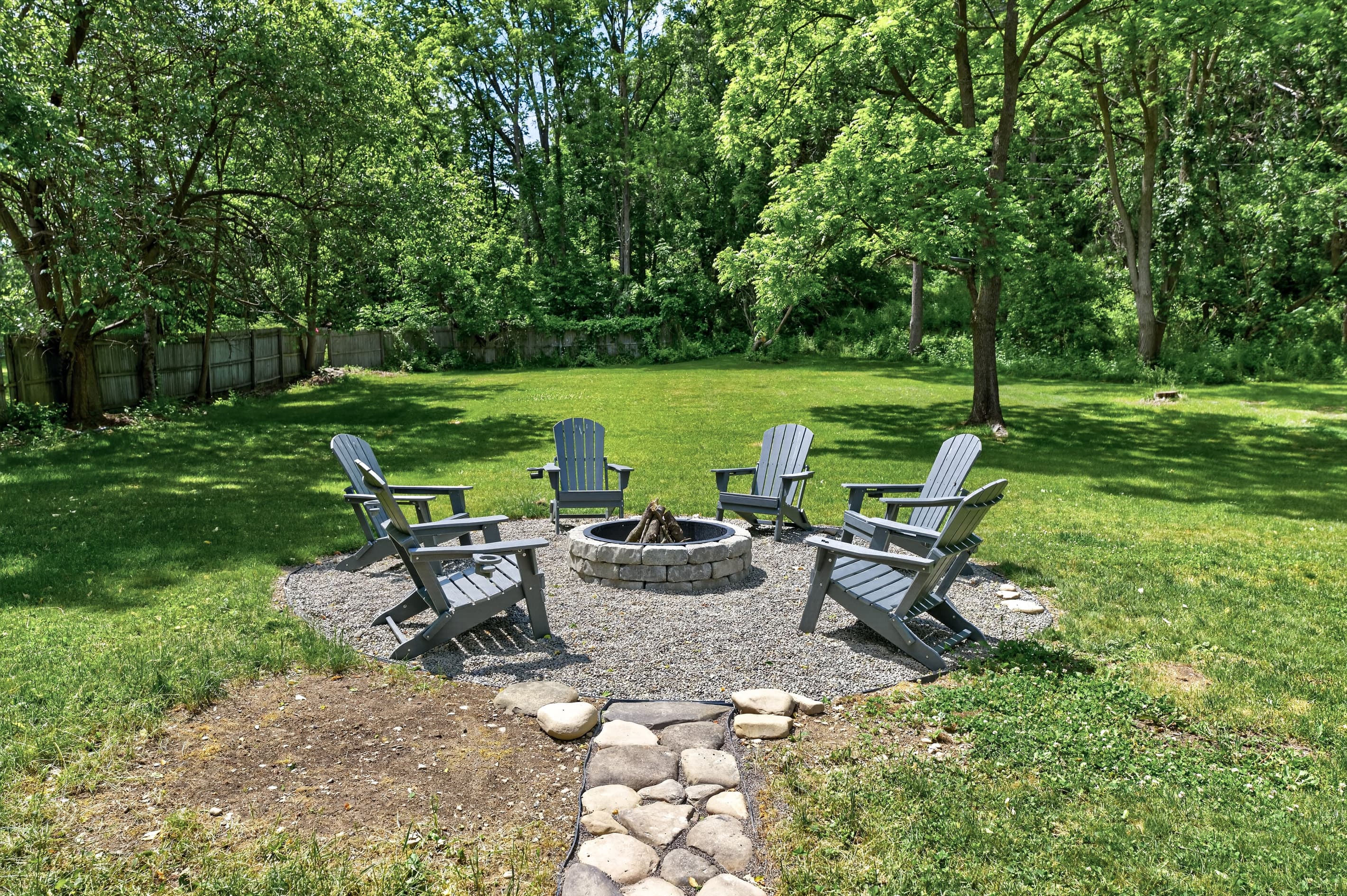 Circular fire pit with Adirondack chairs