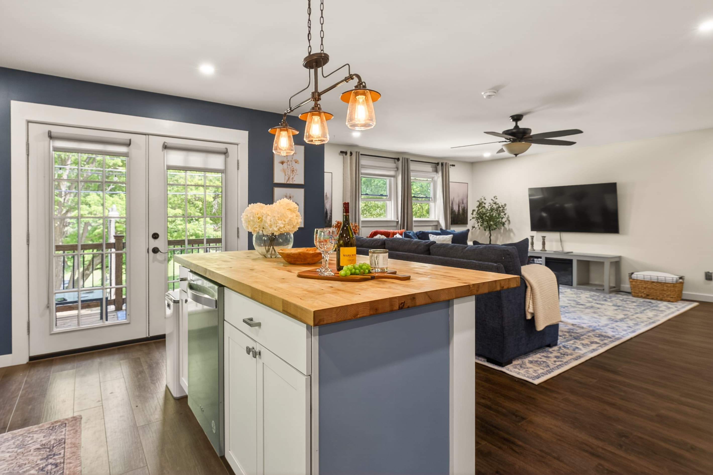 Wood-topped island beneath pendant lights