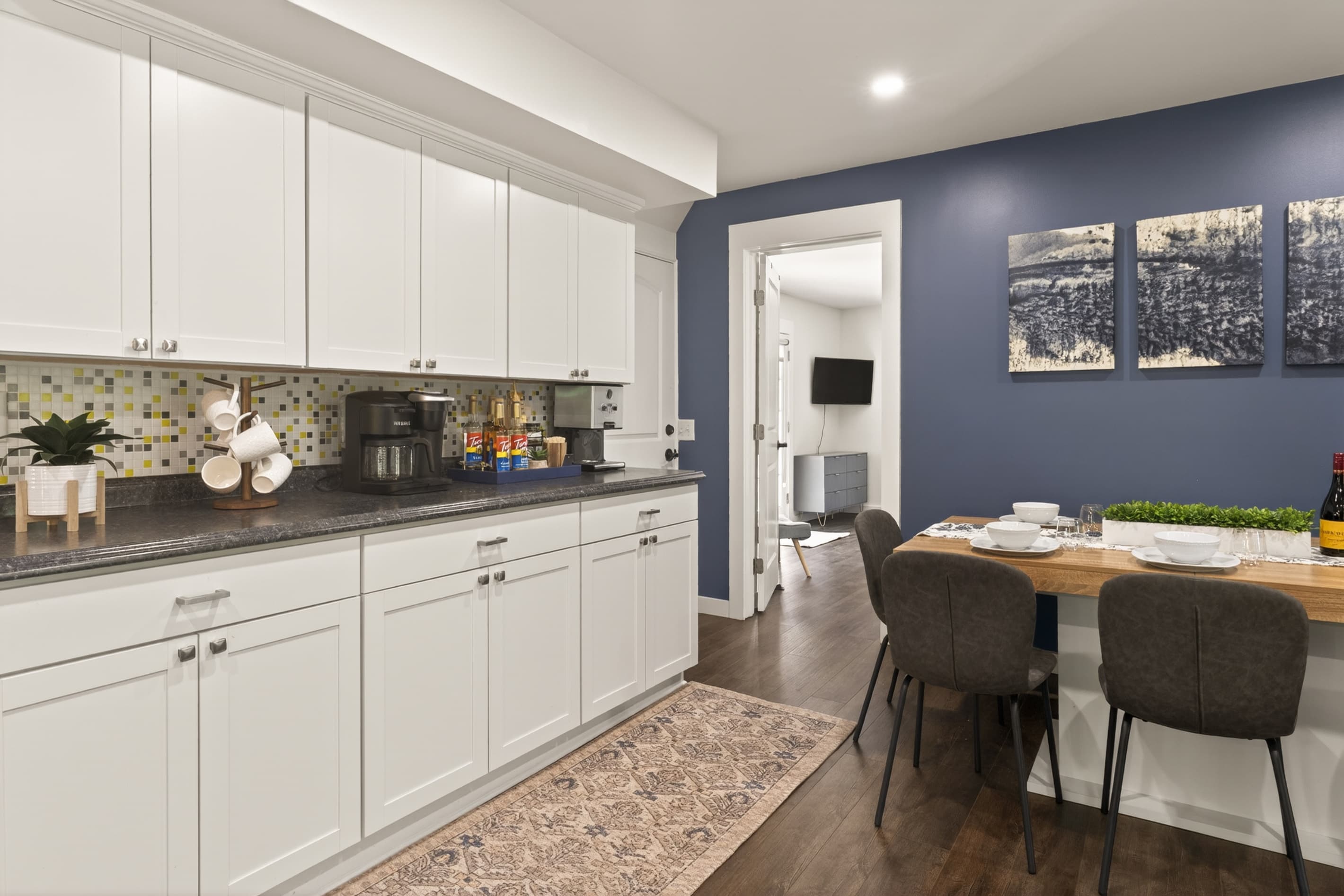 Dining nook beside white kitchen cabinetry