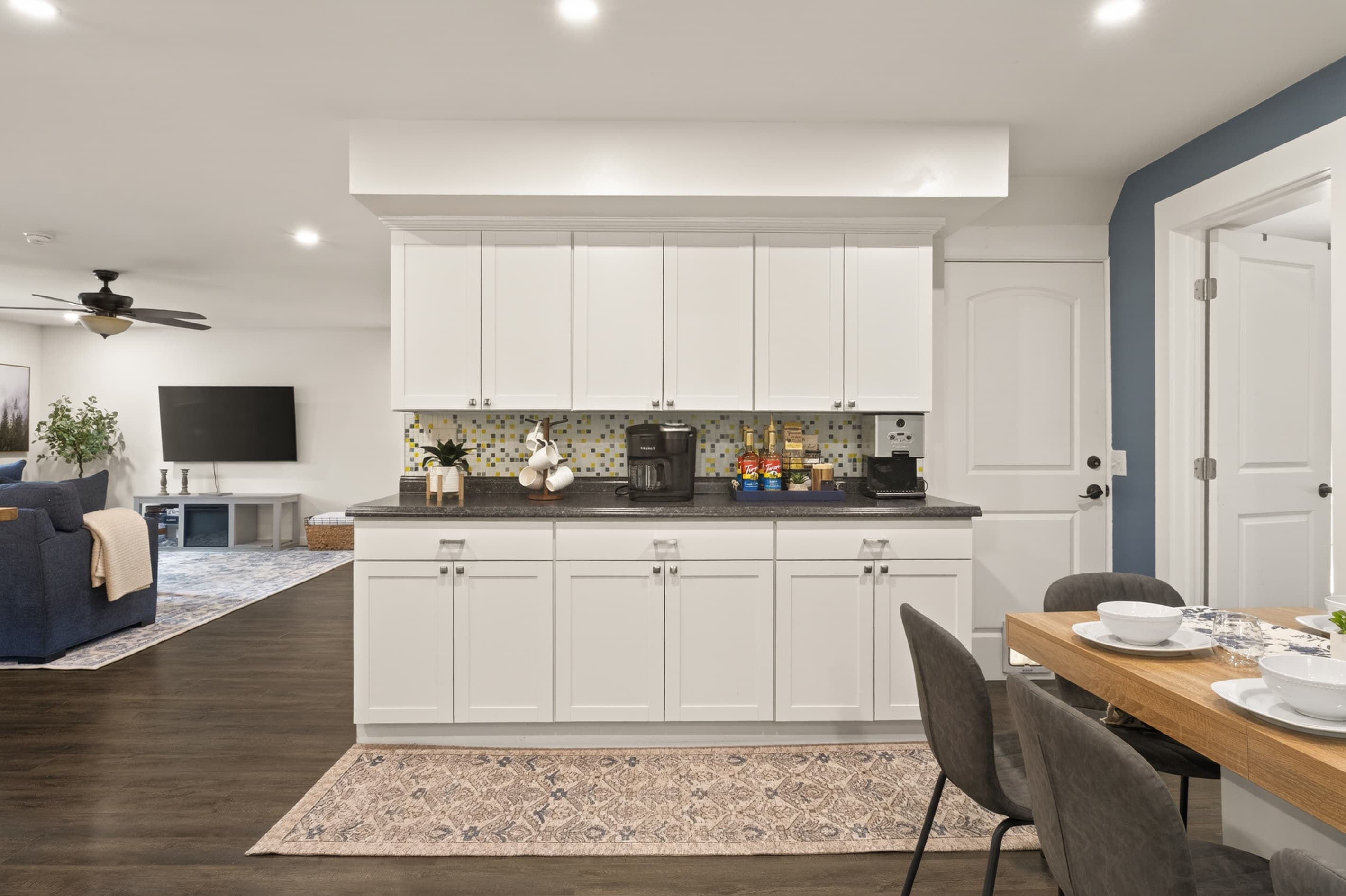 White kitchen cabinets along open dining area