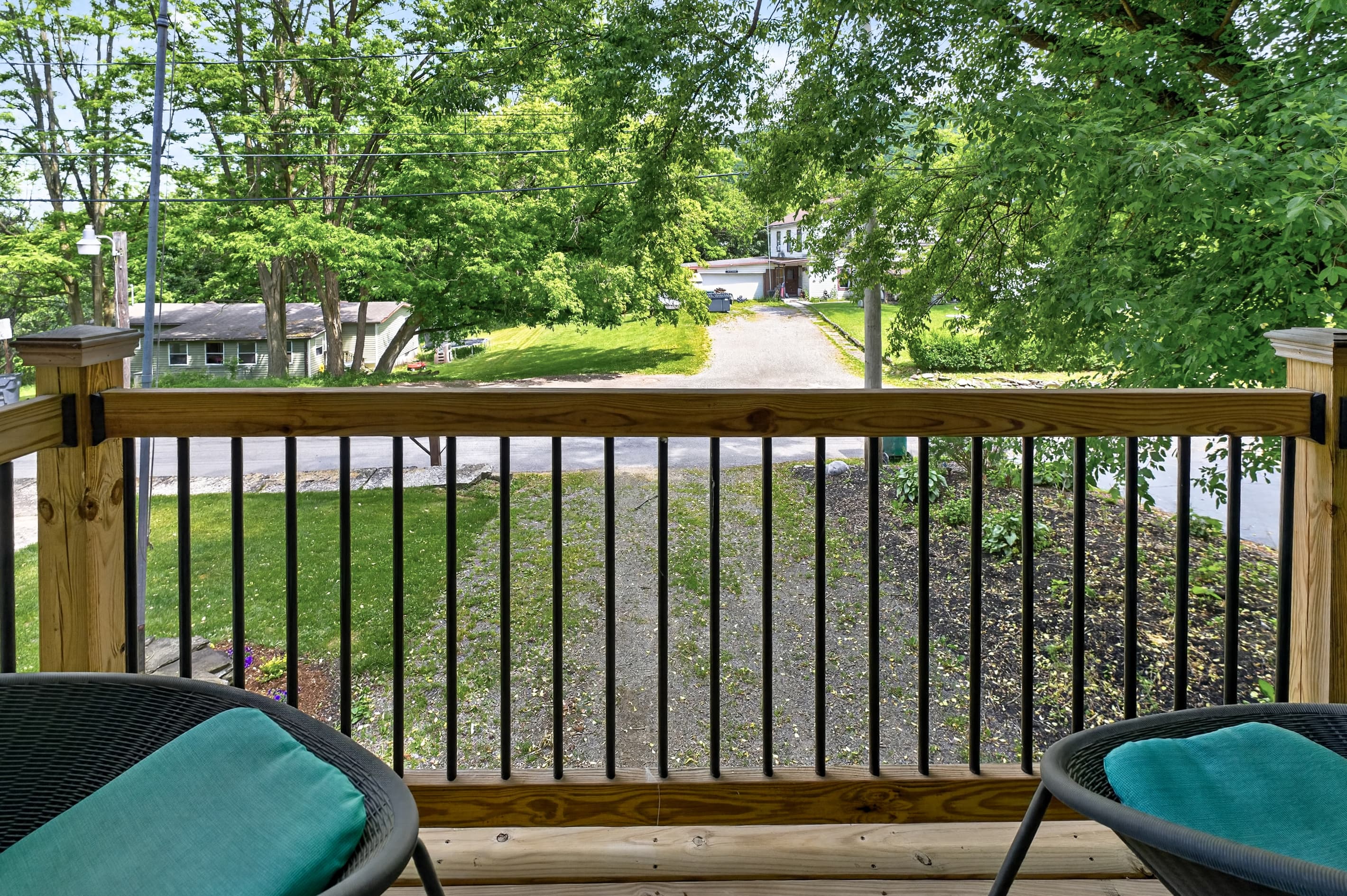 Balcony seating overlooking the wooded yard